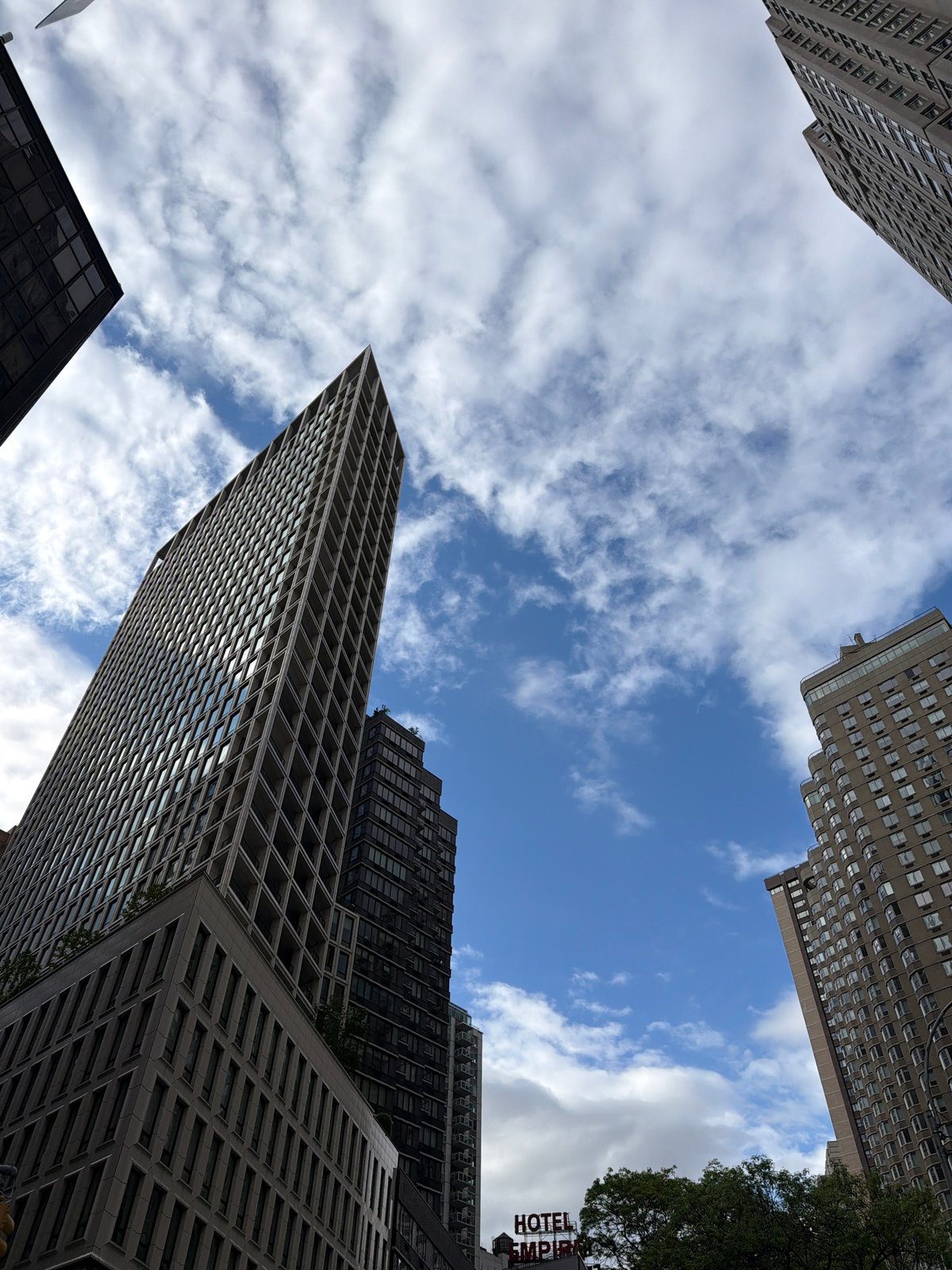 NYC skyscrapers photographed from street level urban canyon perspective