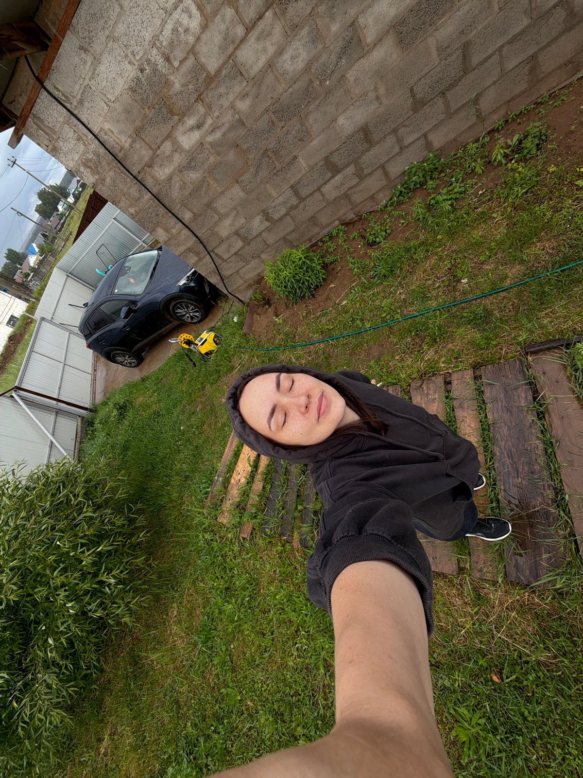 Young woman documents rainy afternoon with selfies, melting ice cream