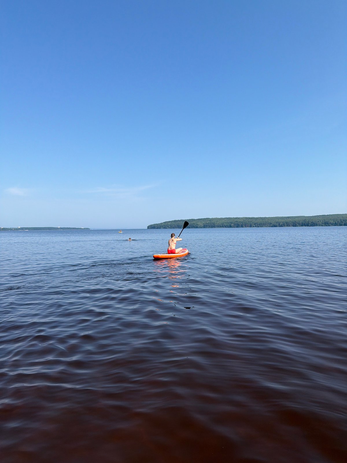 Solo paddleboarding session on a calm lake in Chaikovsky