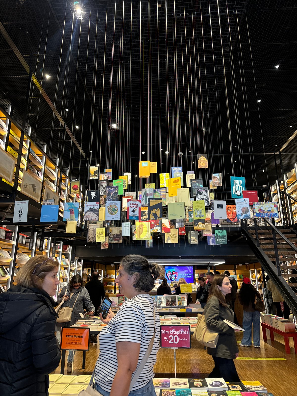 Two women observed together inside modern bookstore