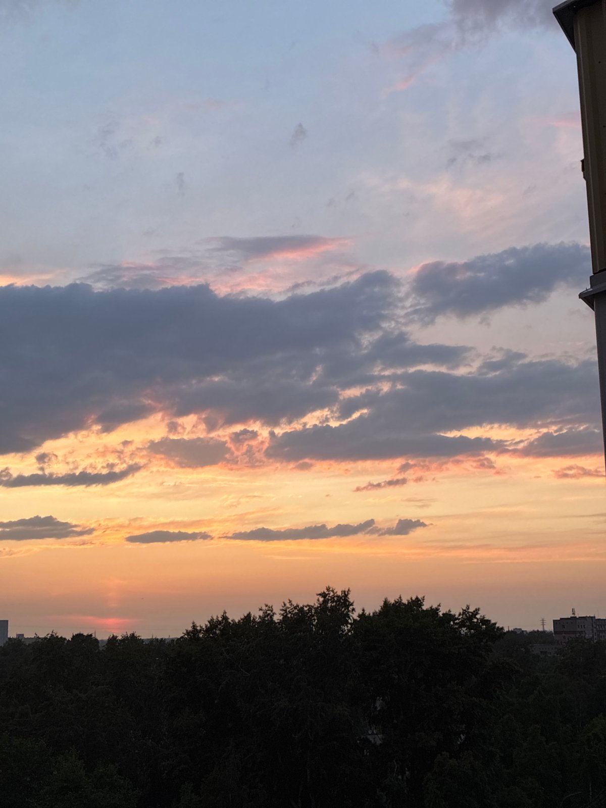 Dramatic sunset transforms city skyline through vibrant evening colors