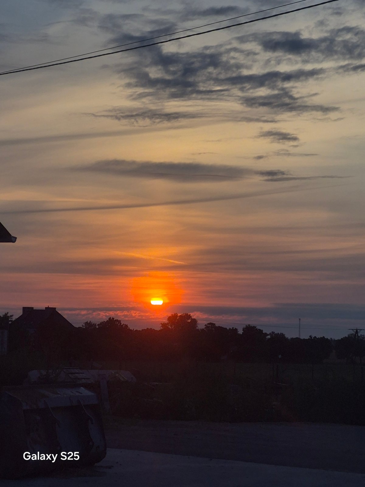 Layered sunset over flat farmland in rural Poland