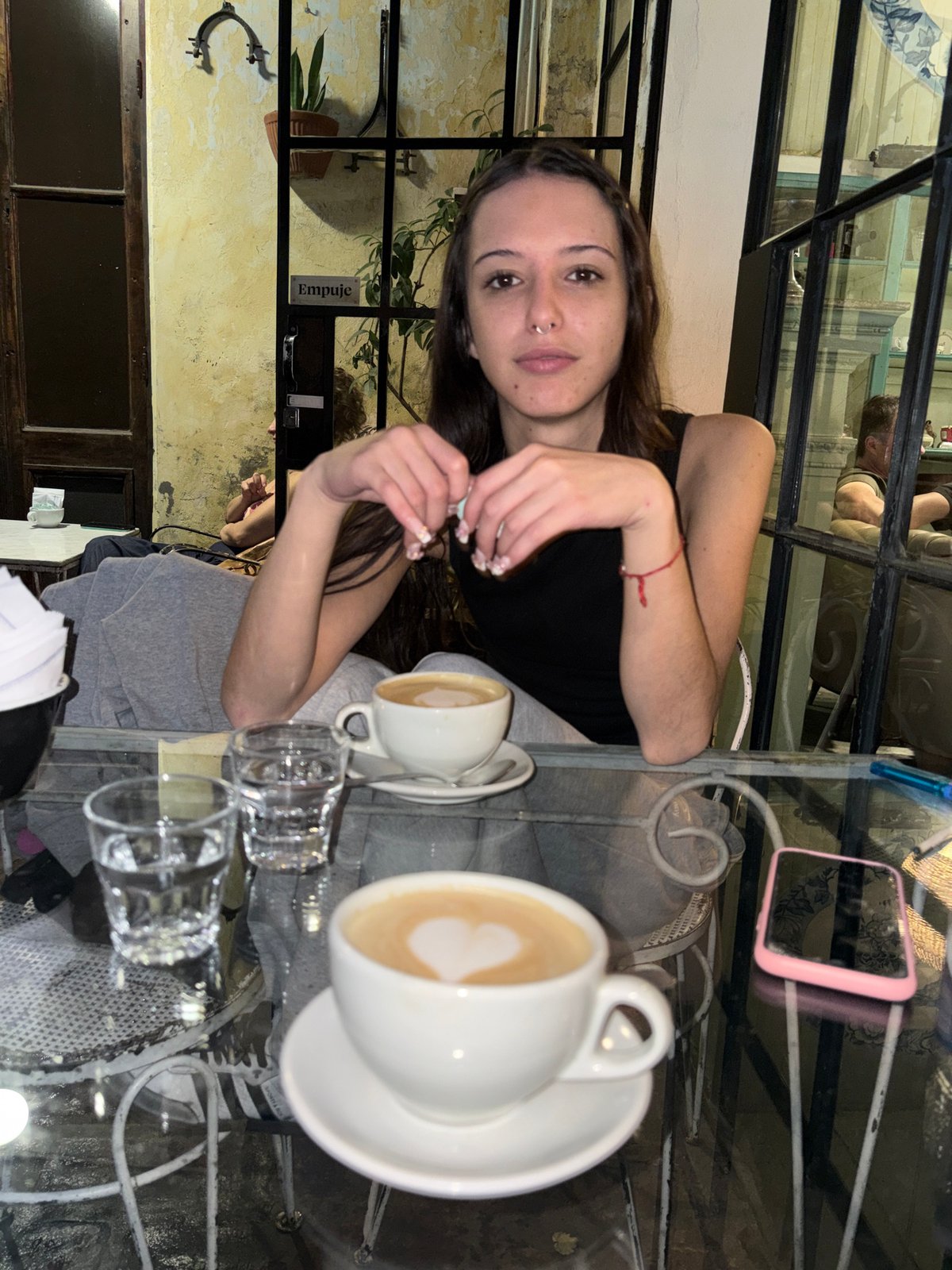 Woman enjoys coffee at Buenos Aires cafe