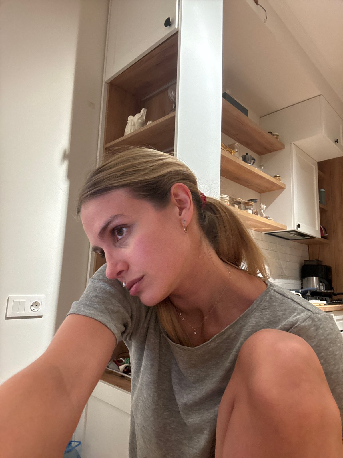 Woman prepares food in kitchen during evening hours
