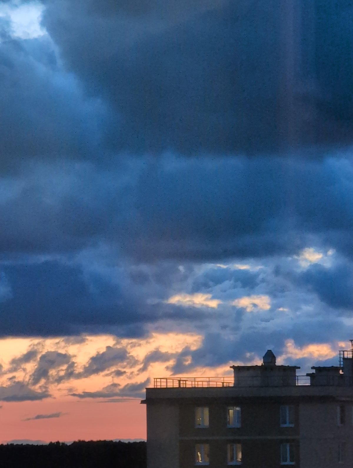 Storm clouds roll over Saint Petersburg apartment blocks at twilight