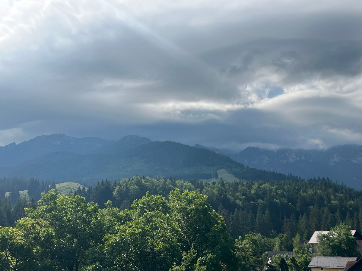 Inside and outside a rustic mountain cabin on an overcast morning
