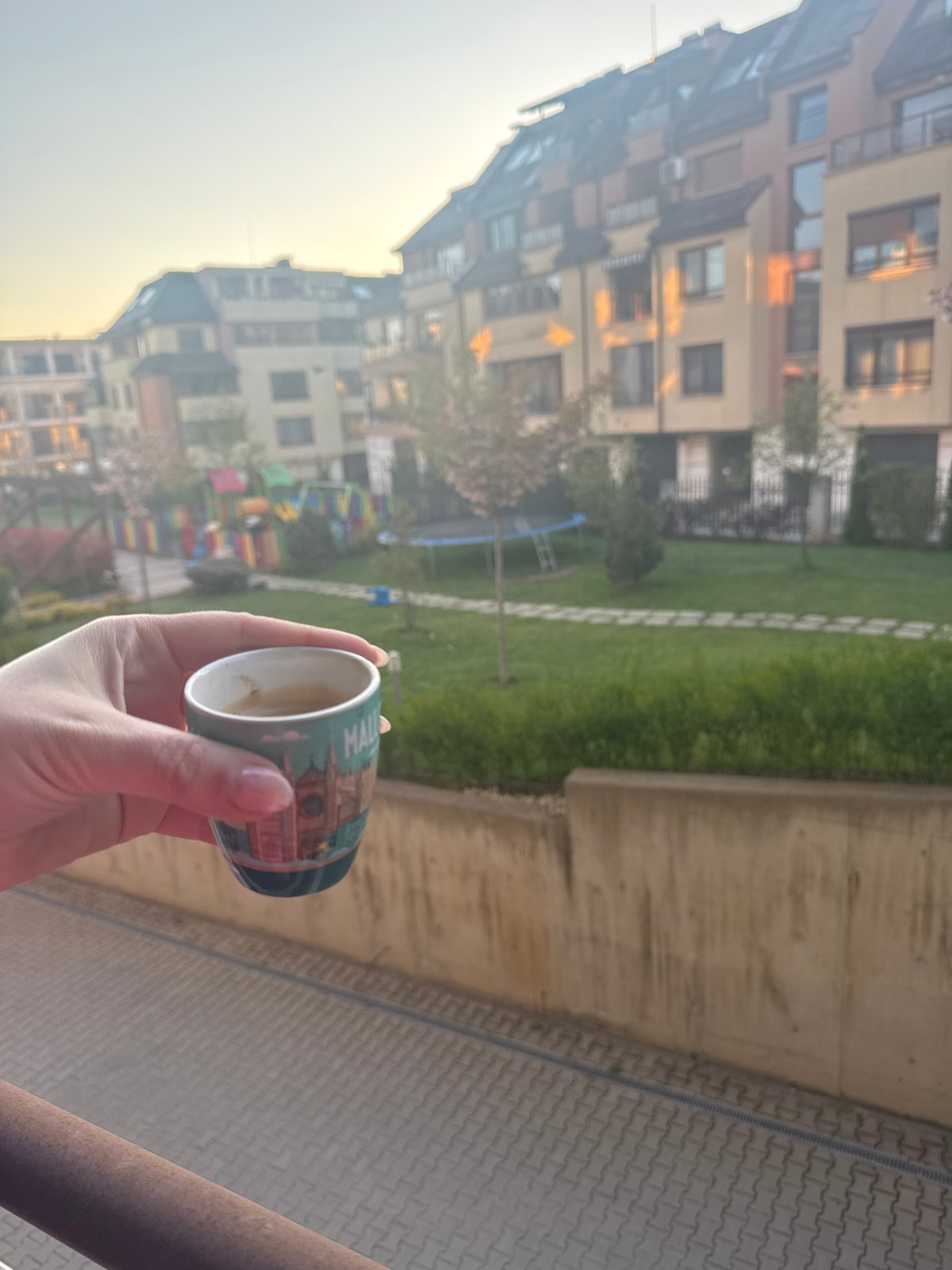Morning balcony moment captured in Sofia residential courtyard
