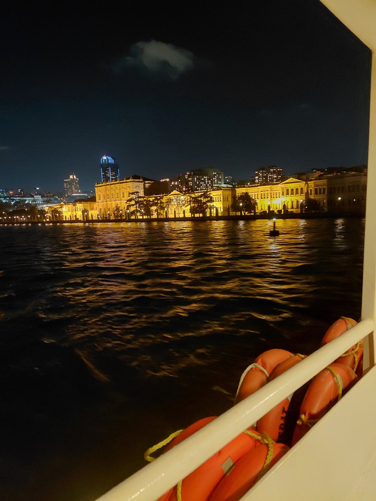 Nighttime ferry view captures illuminated Istanbul waterfront from Beşiktaş