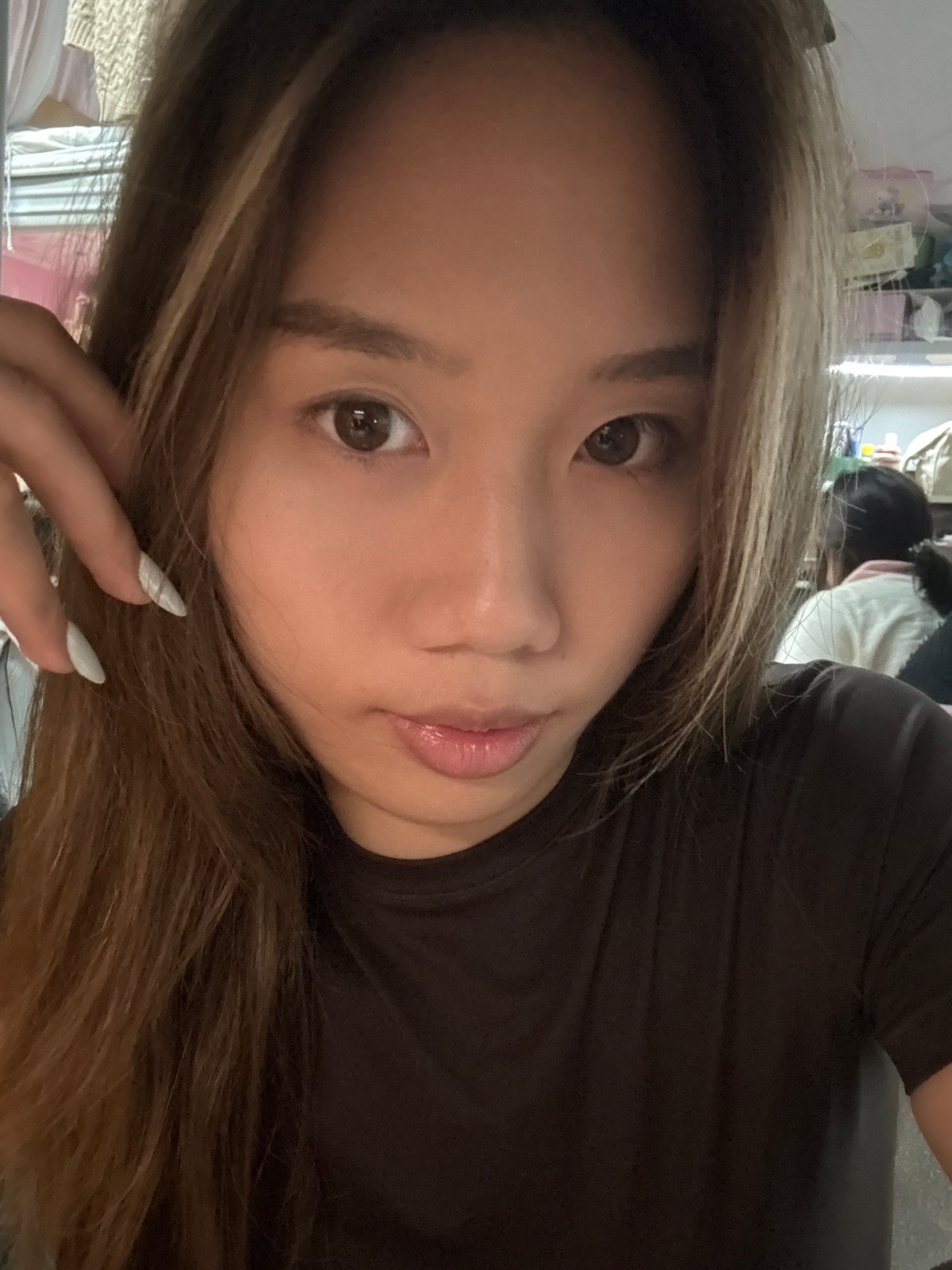 Woman takes selfie session in cluttered Chongqing room