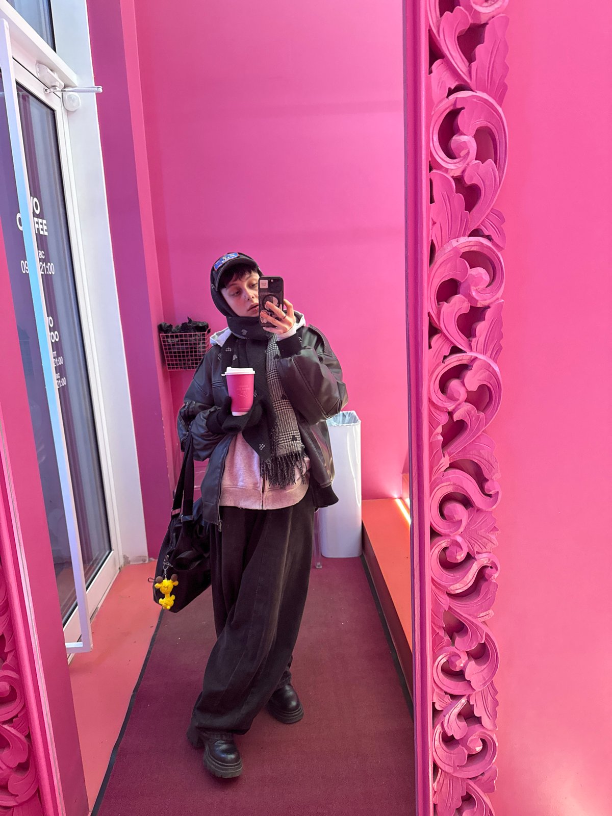 Person takes selfie with pink coffee in Moscow cafe