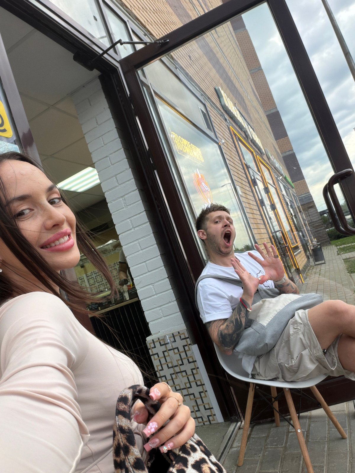 Woman takes selfies outside Saint Petersburg vapor shop