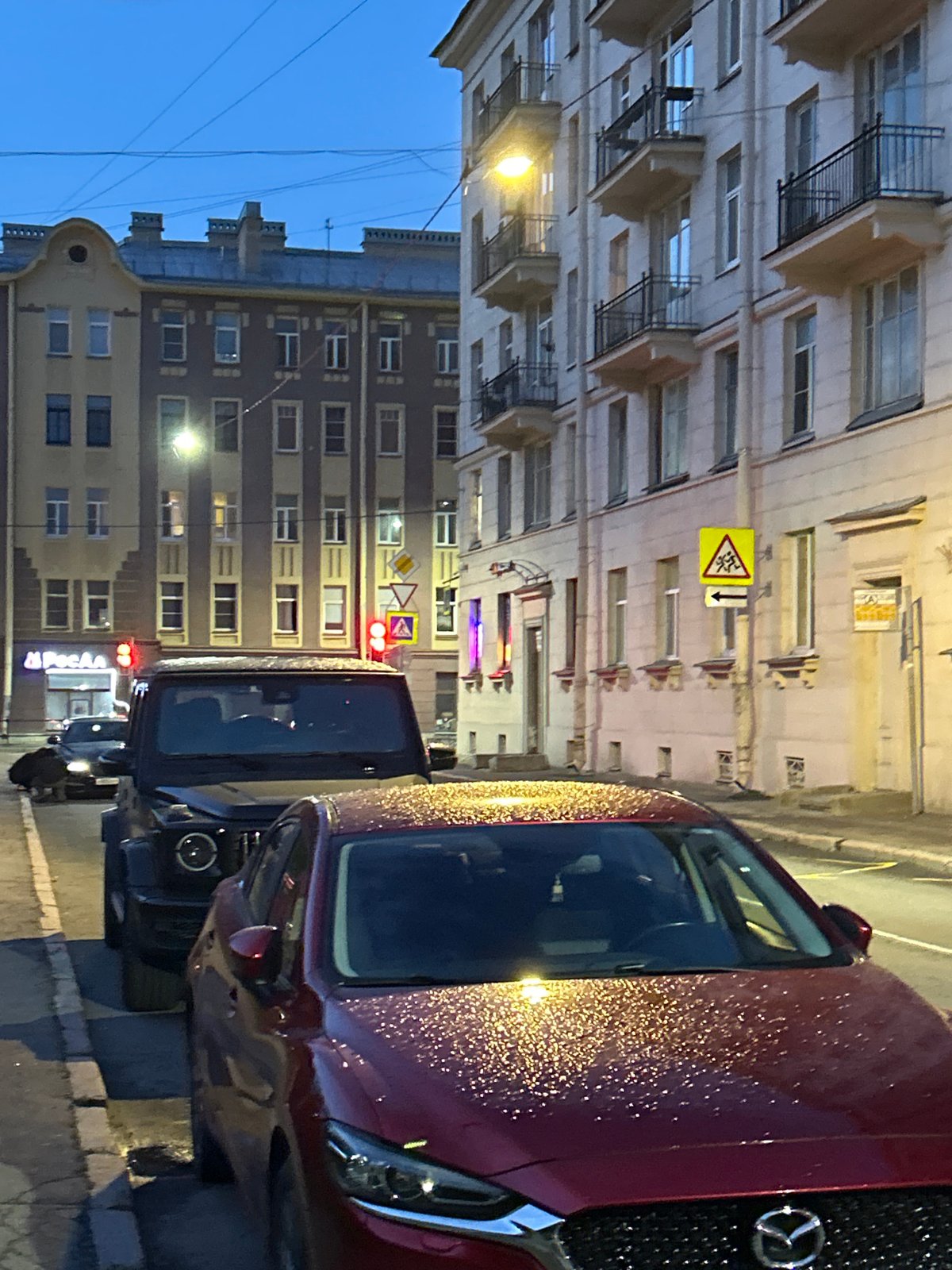 Dodge Hellcats parked on a Russian city street at dusk