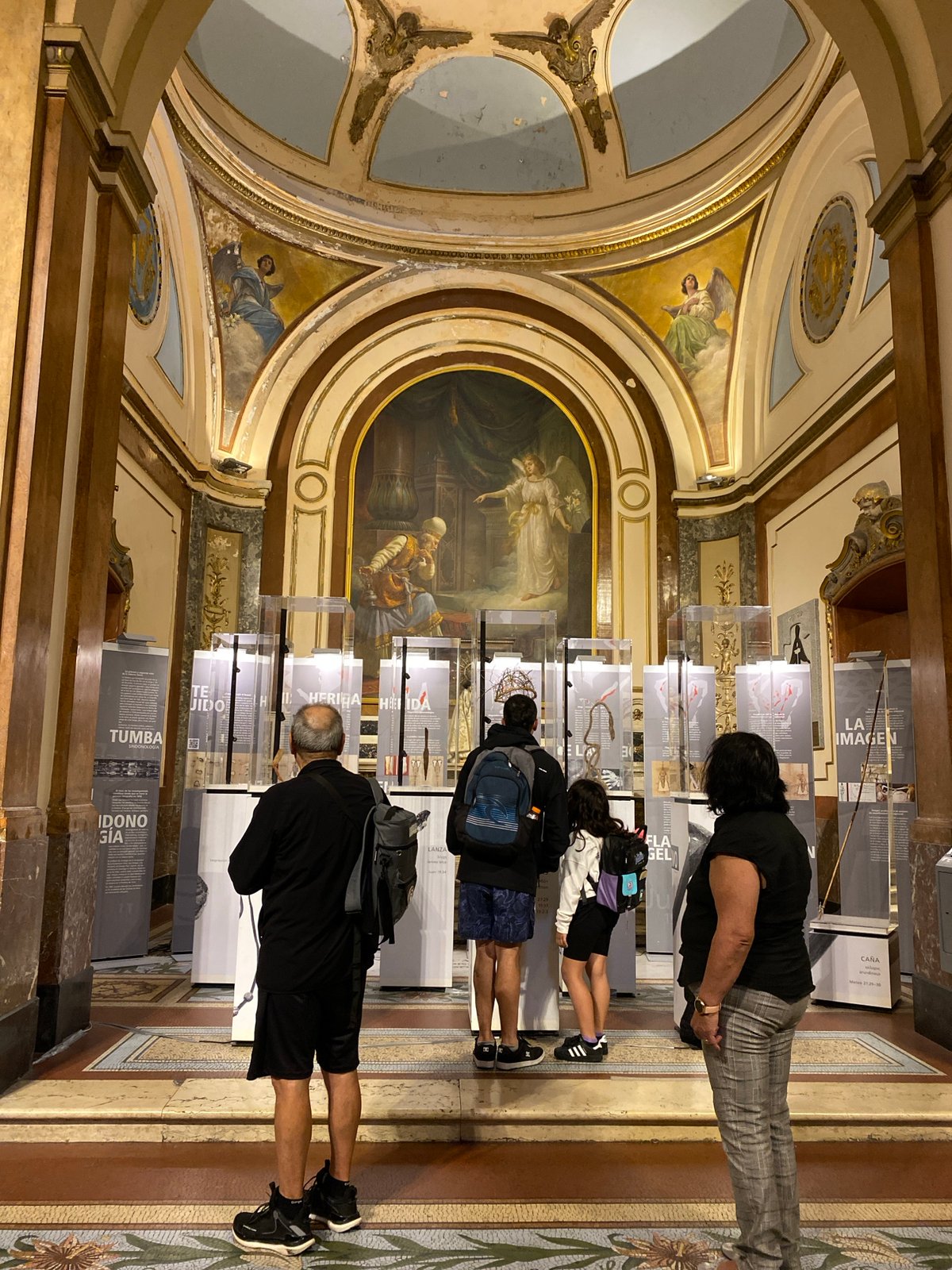 Visitor documents ornate cathedral interior in Buenos Aires