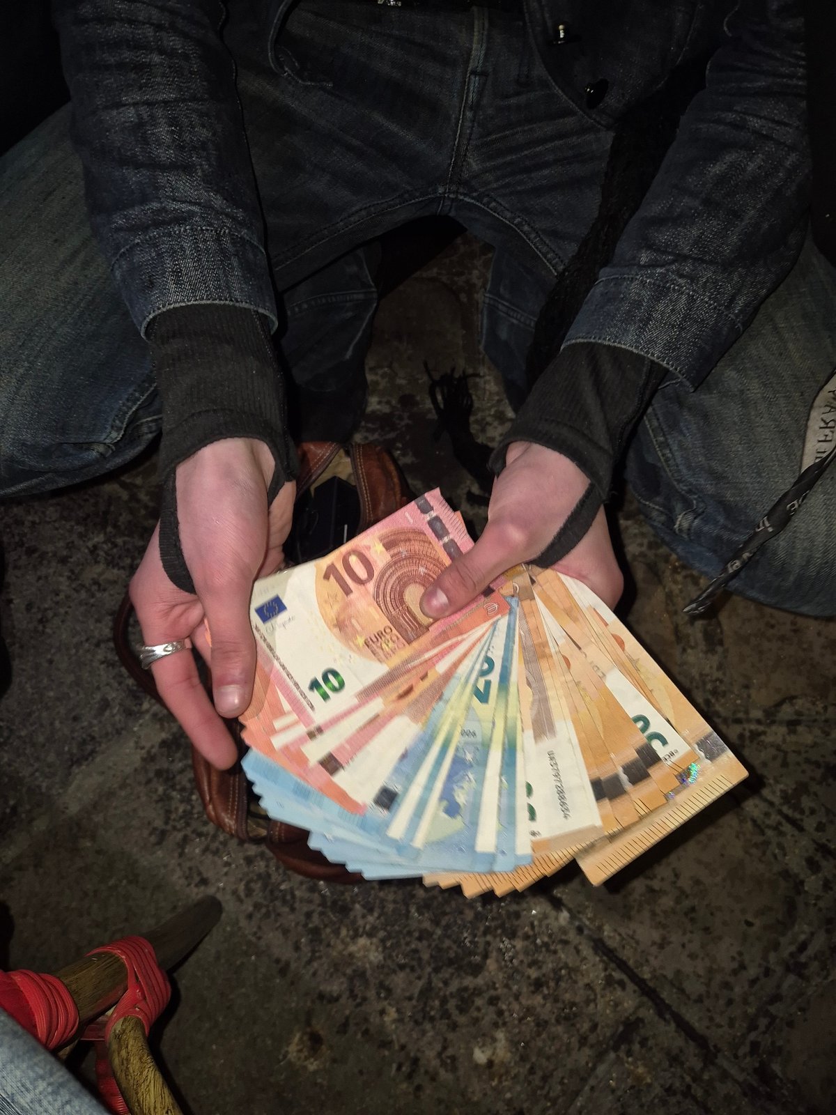 Person displays euro banknotes indoors