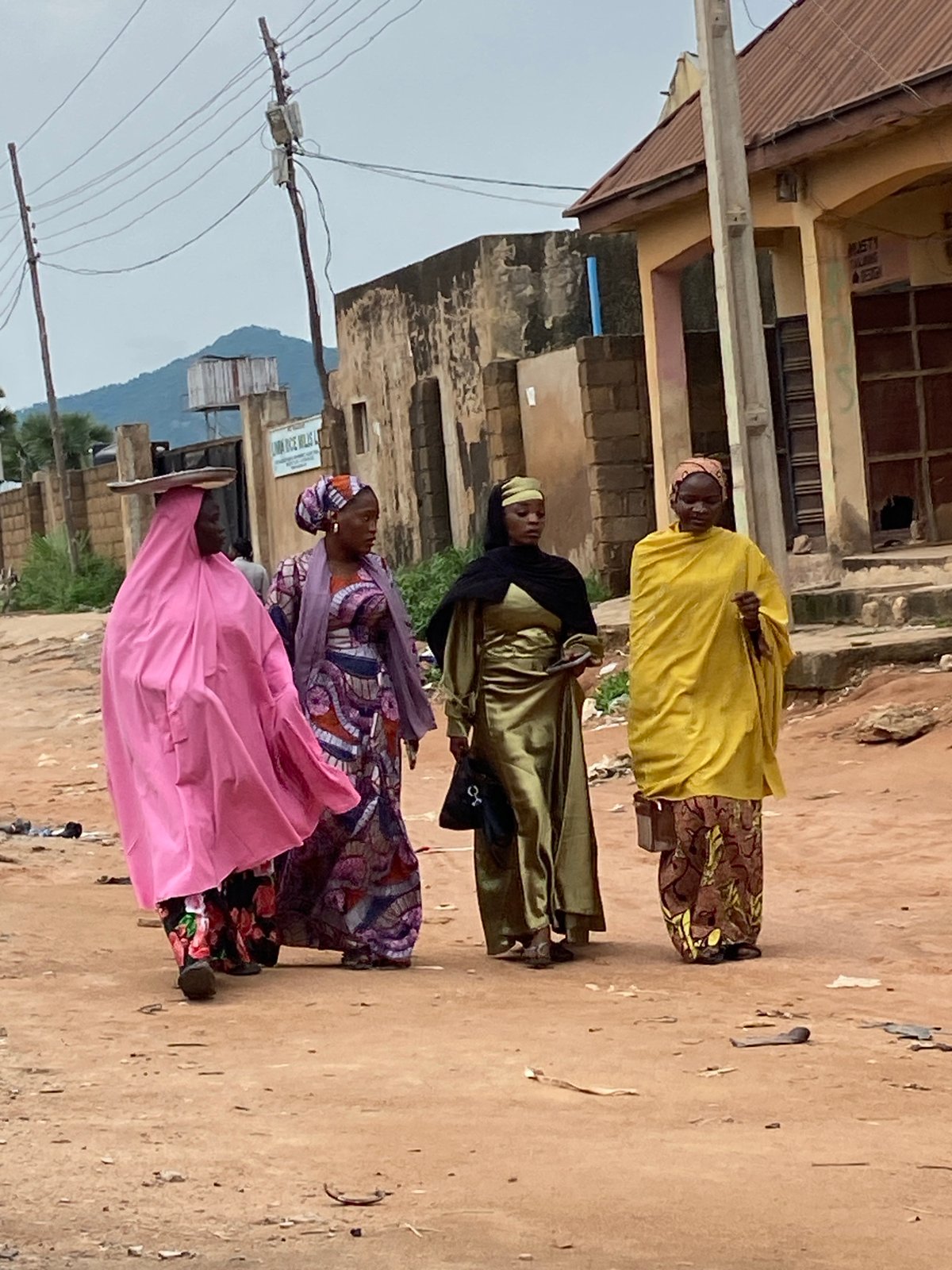 Afternoon street life in Kuson, Nigeria — people, transport, and trade