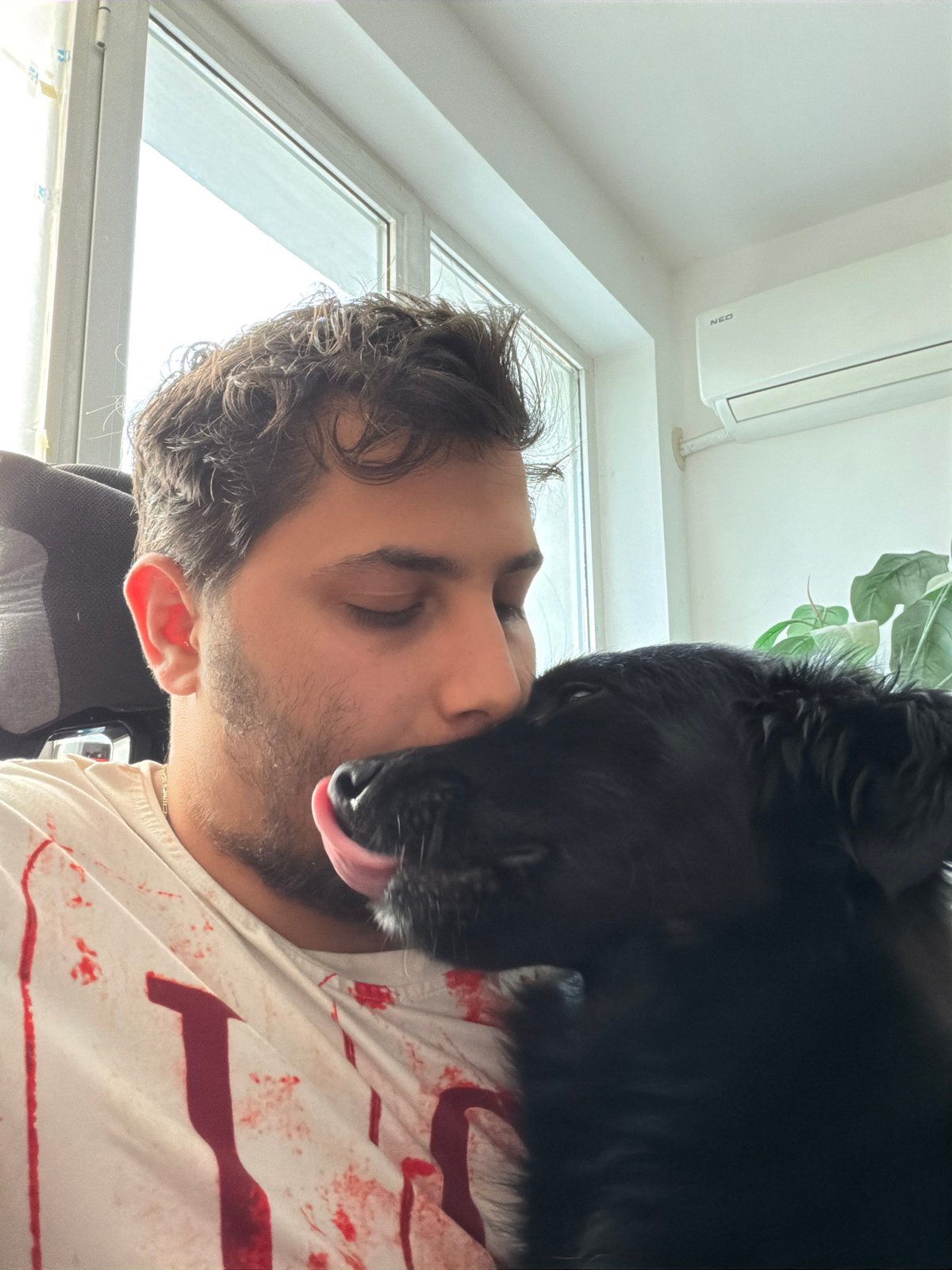 Man shares affectionate moment with black dog in Sofia