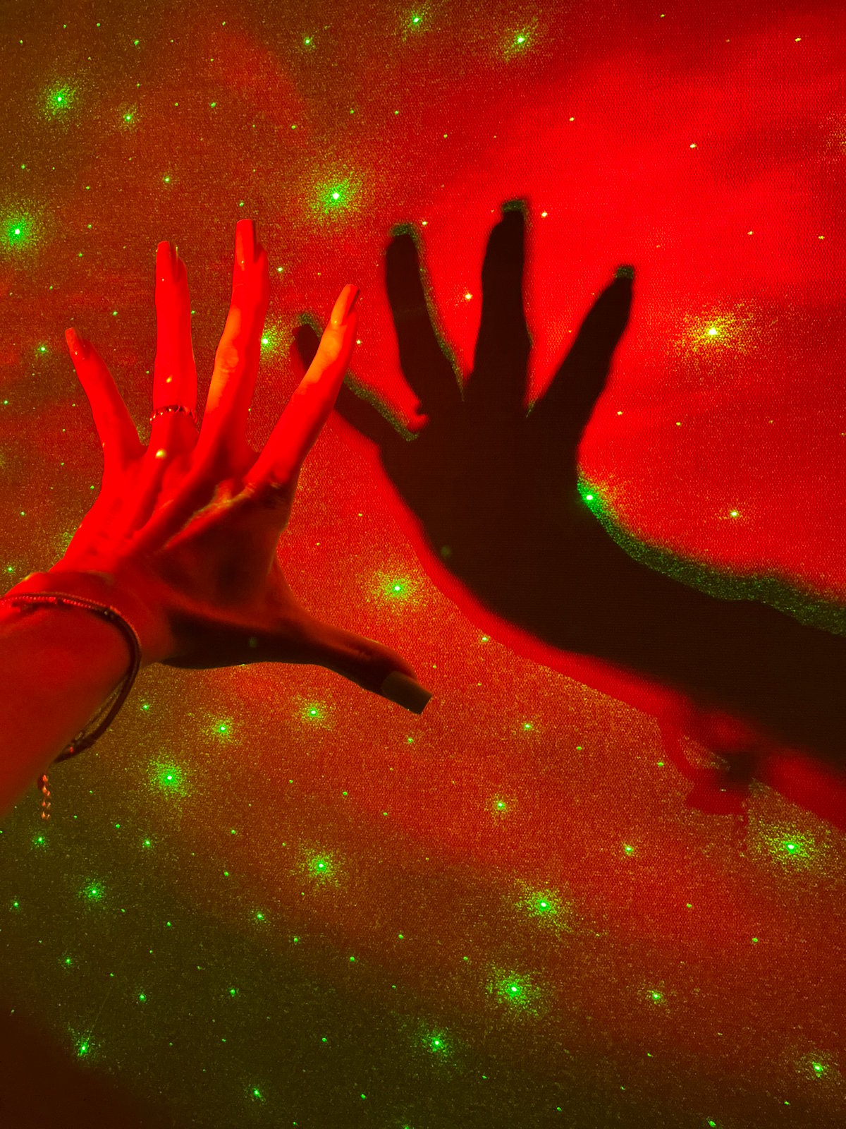 Hands play in galaxy projector light in a Nizhny Novgorod room