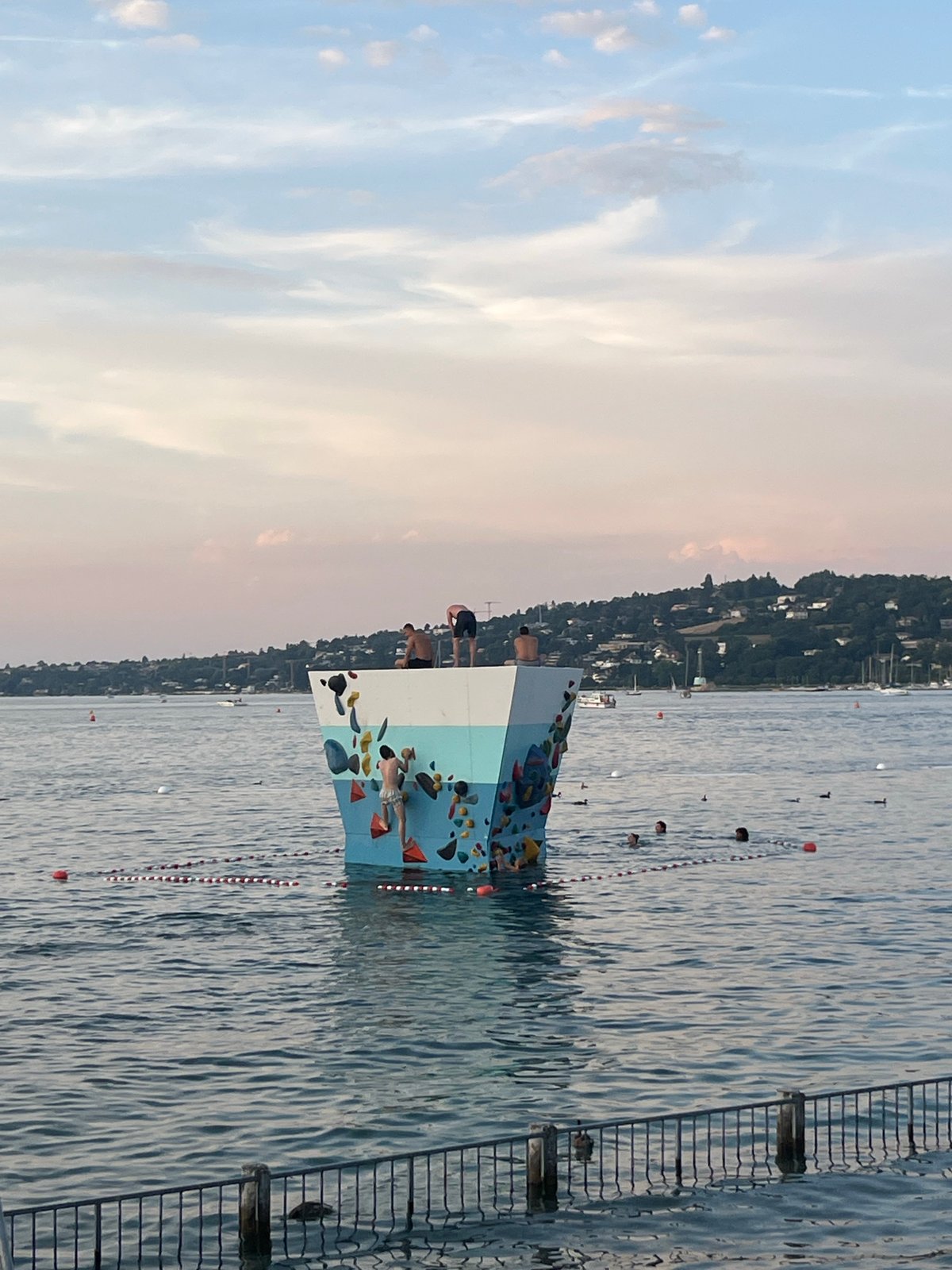 Golden hour at Geneva's Plage des Eaux-Vives, lake and mountains