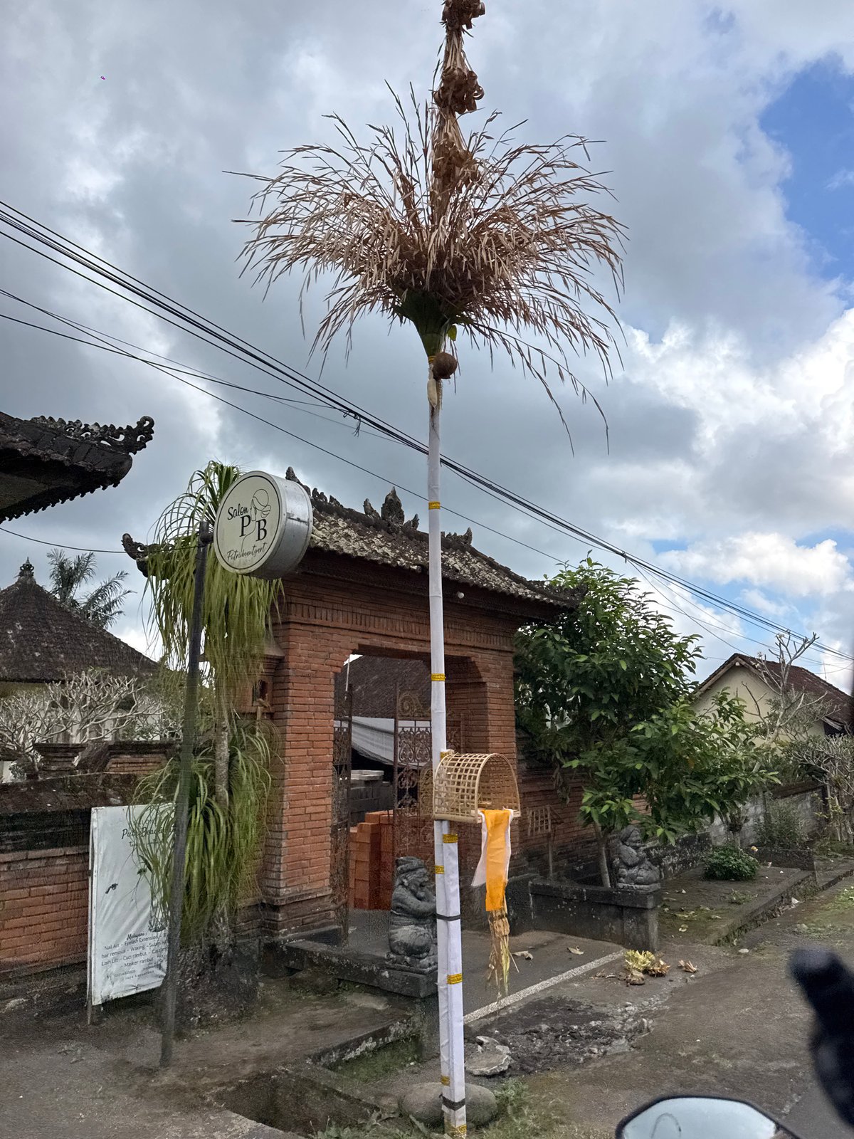 Penjors and roadside life in Susut on a cloudy day