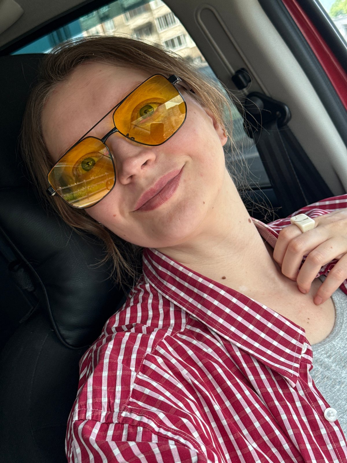 Person in striped shirt rests in car, Izhevsk