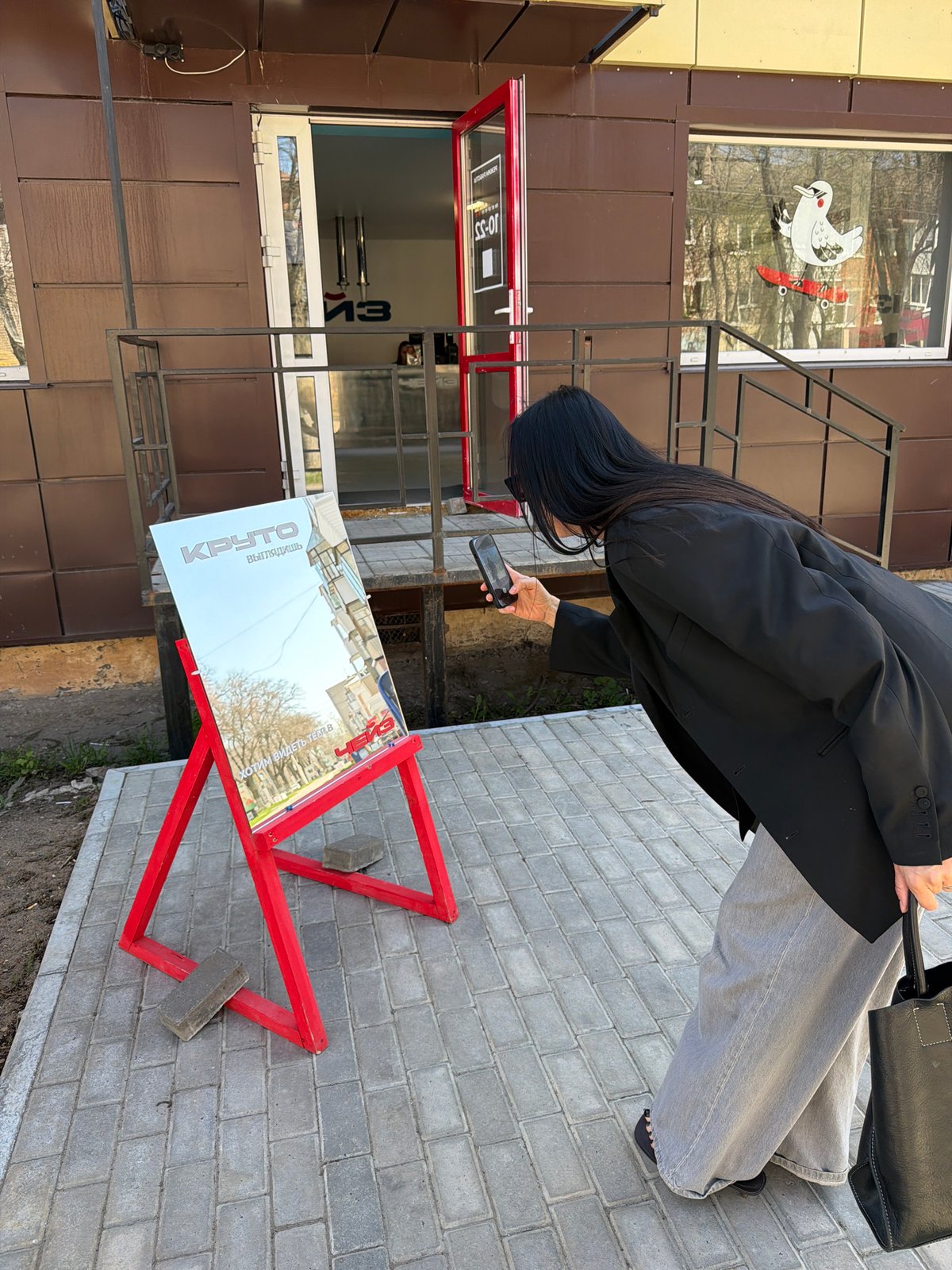 Person photographs business sign in Chaikovsky, Russia