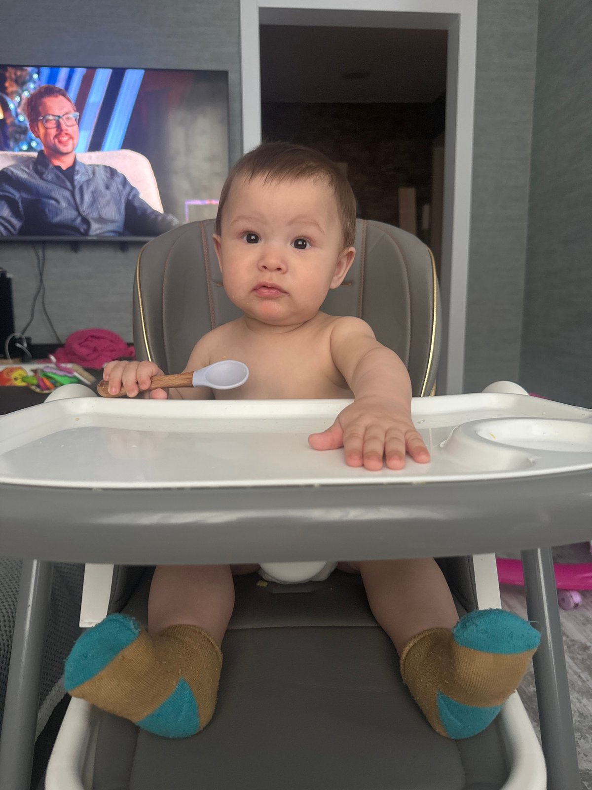 Baby's Messy Mealtime Captured During Self-Feeding Session