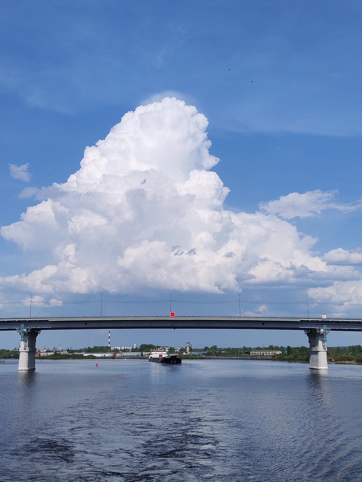 Barge passes under bridge on Sheksna River in Russia