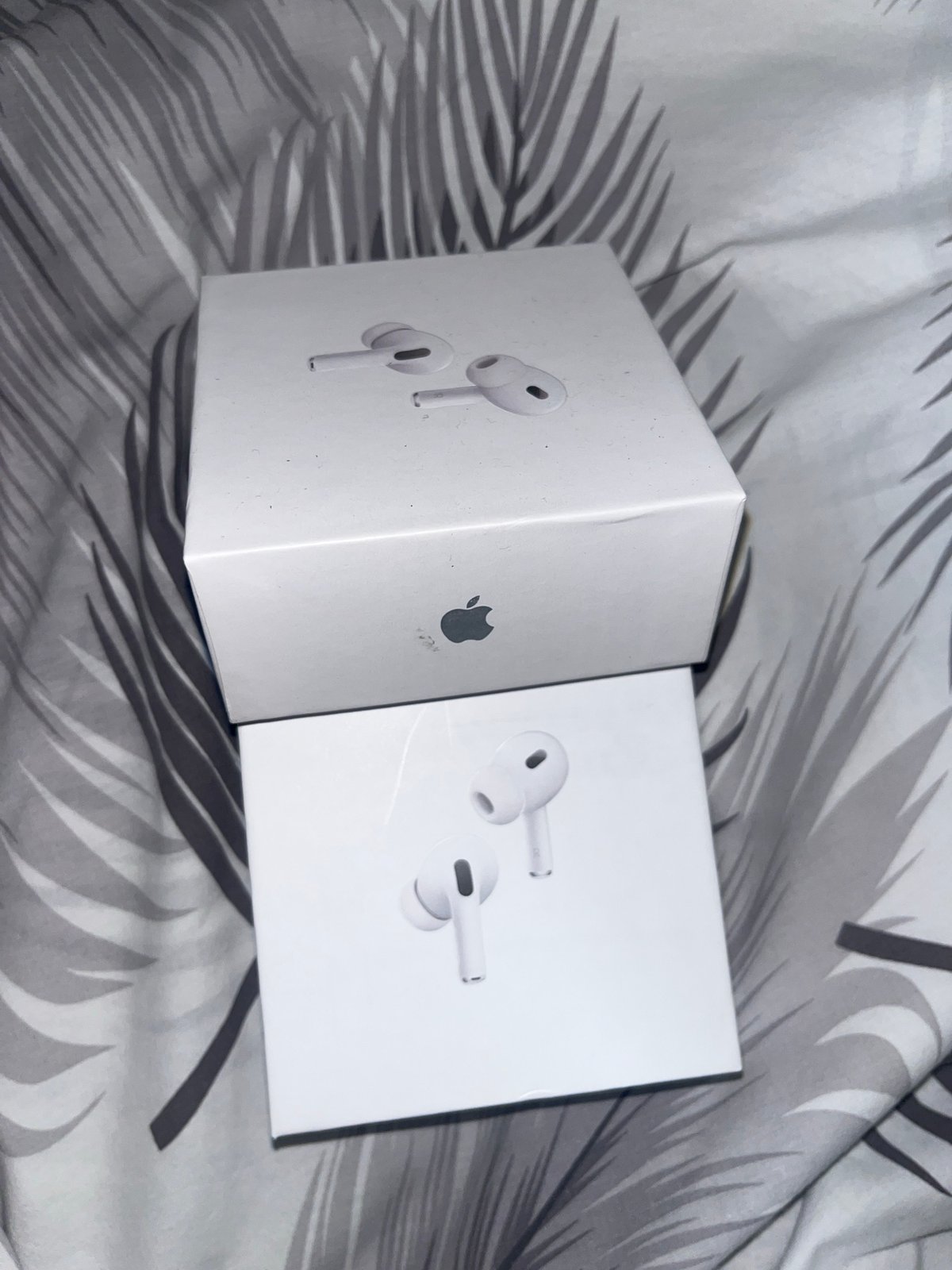 Apple AirPods Pro boxes spotted on patterned fabric in Laval