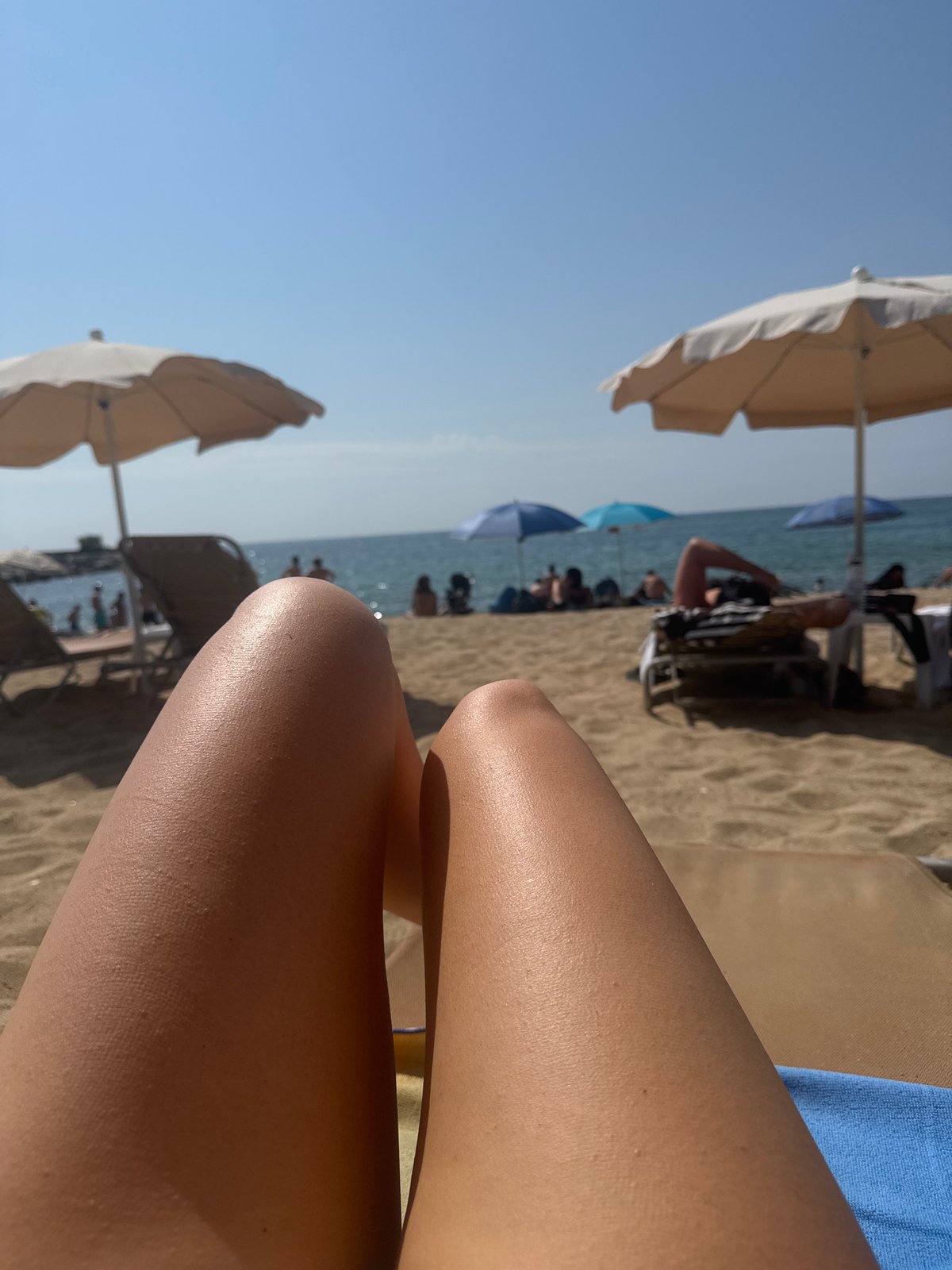 Lazy beach morning at Barceloneta with coastal path views