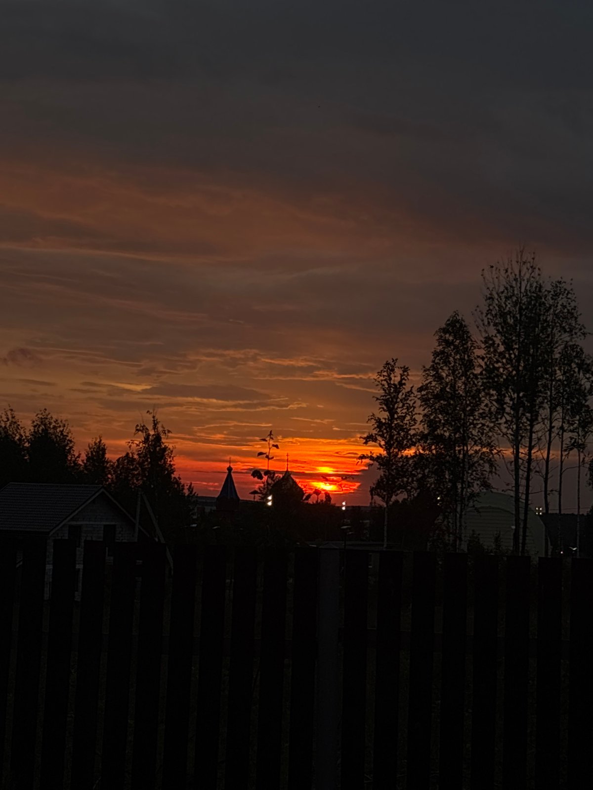 Sunset gathering on wooden deck in Gubakha, Russia