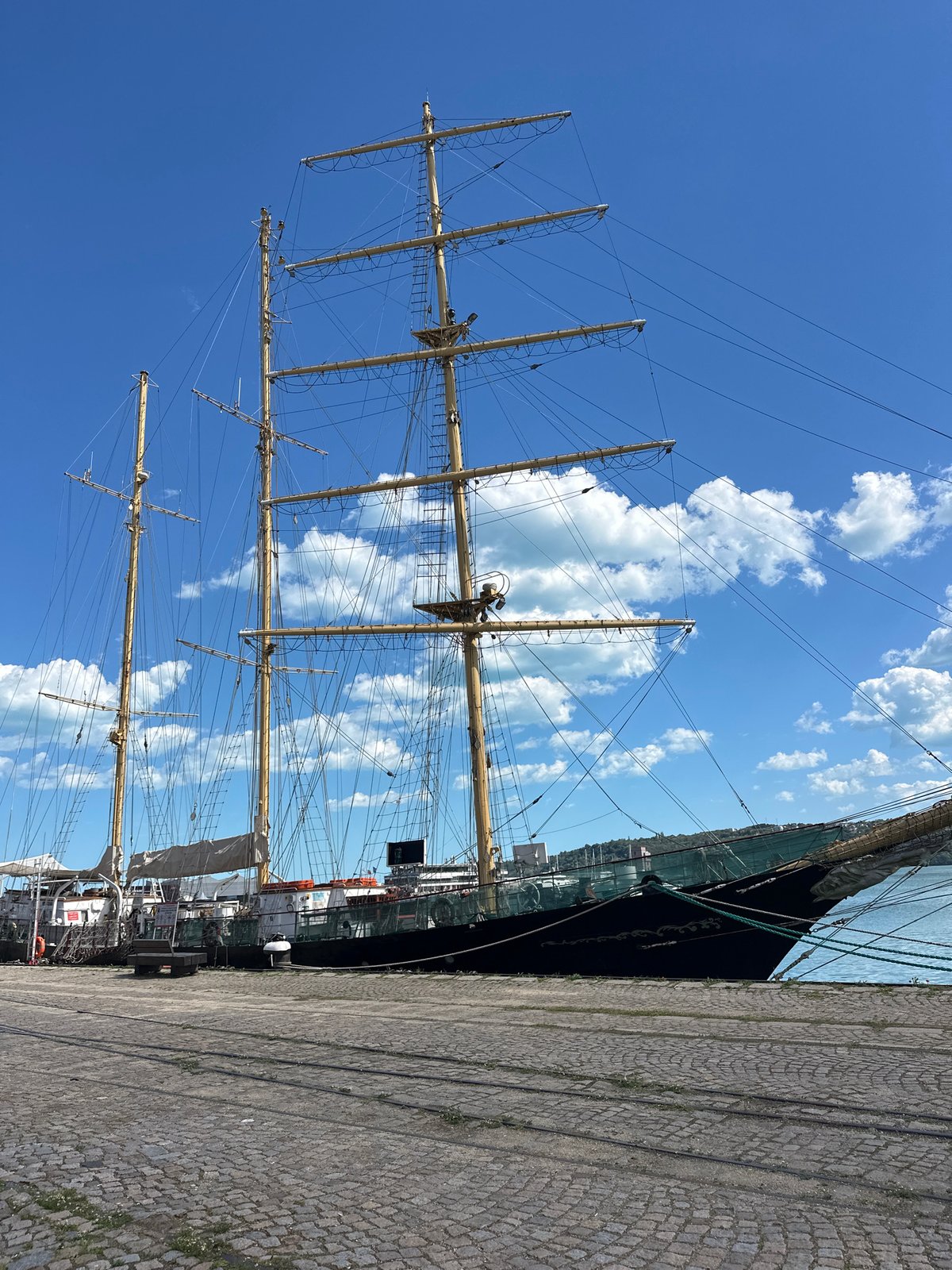 Luxury vehicles spotted near historic sailing ship in Varna harbor