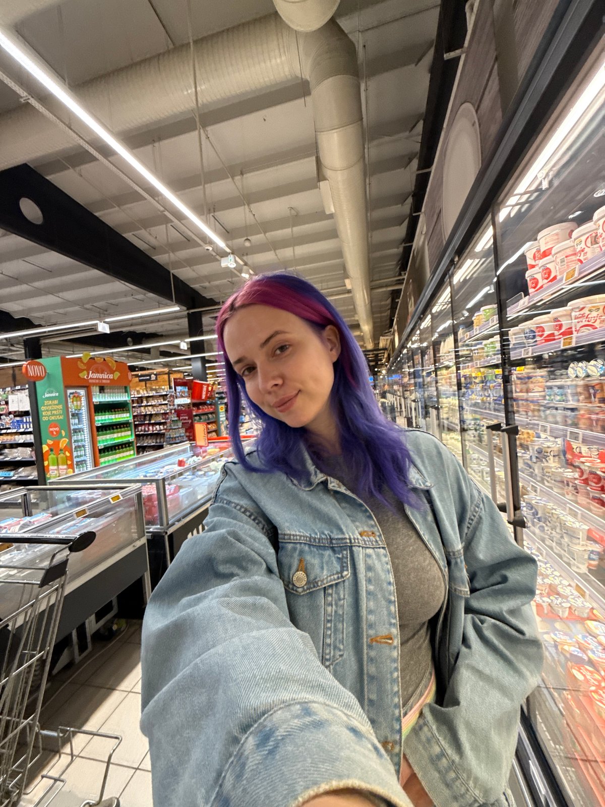 Woman with colorful hair shops, photographs Venus flytraps in Zagreb