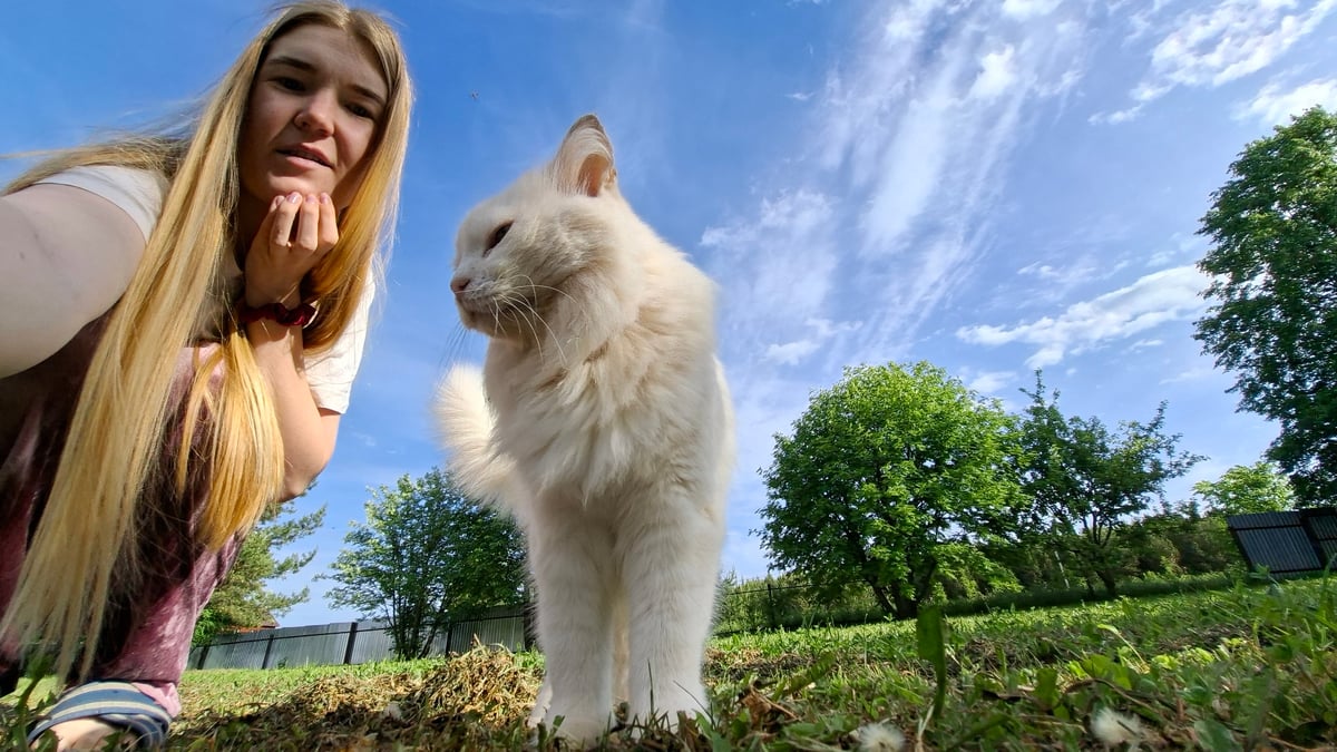 Woman photographs outdoor portrait session with cat in Russia