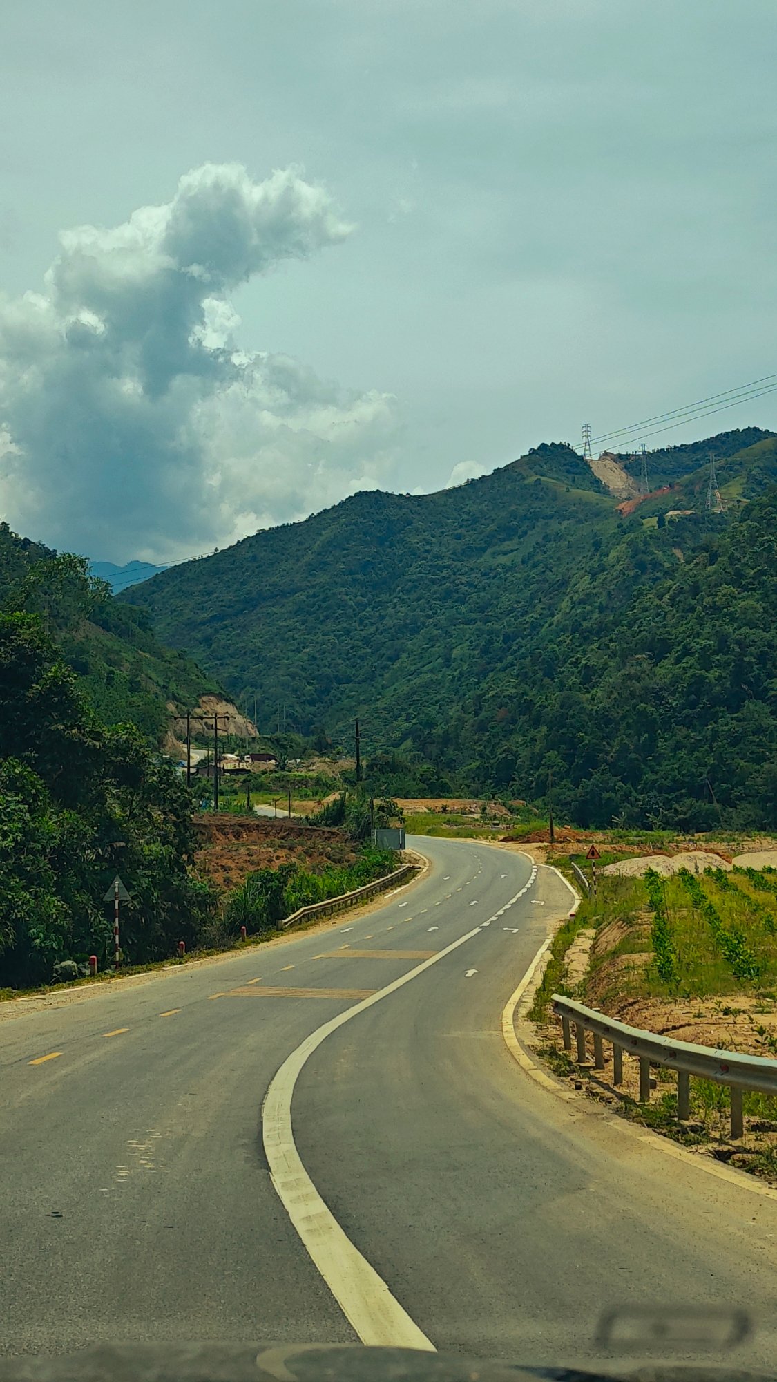 Vehicle travels winding mountain road in Duong Quy, Vietnam