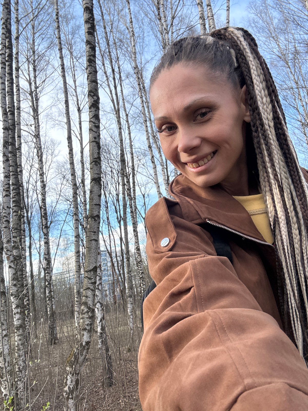 Woman takes outdoor selfies in Russian park setting