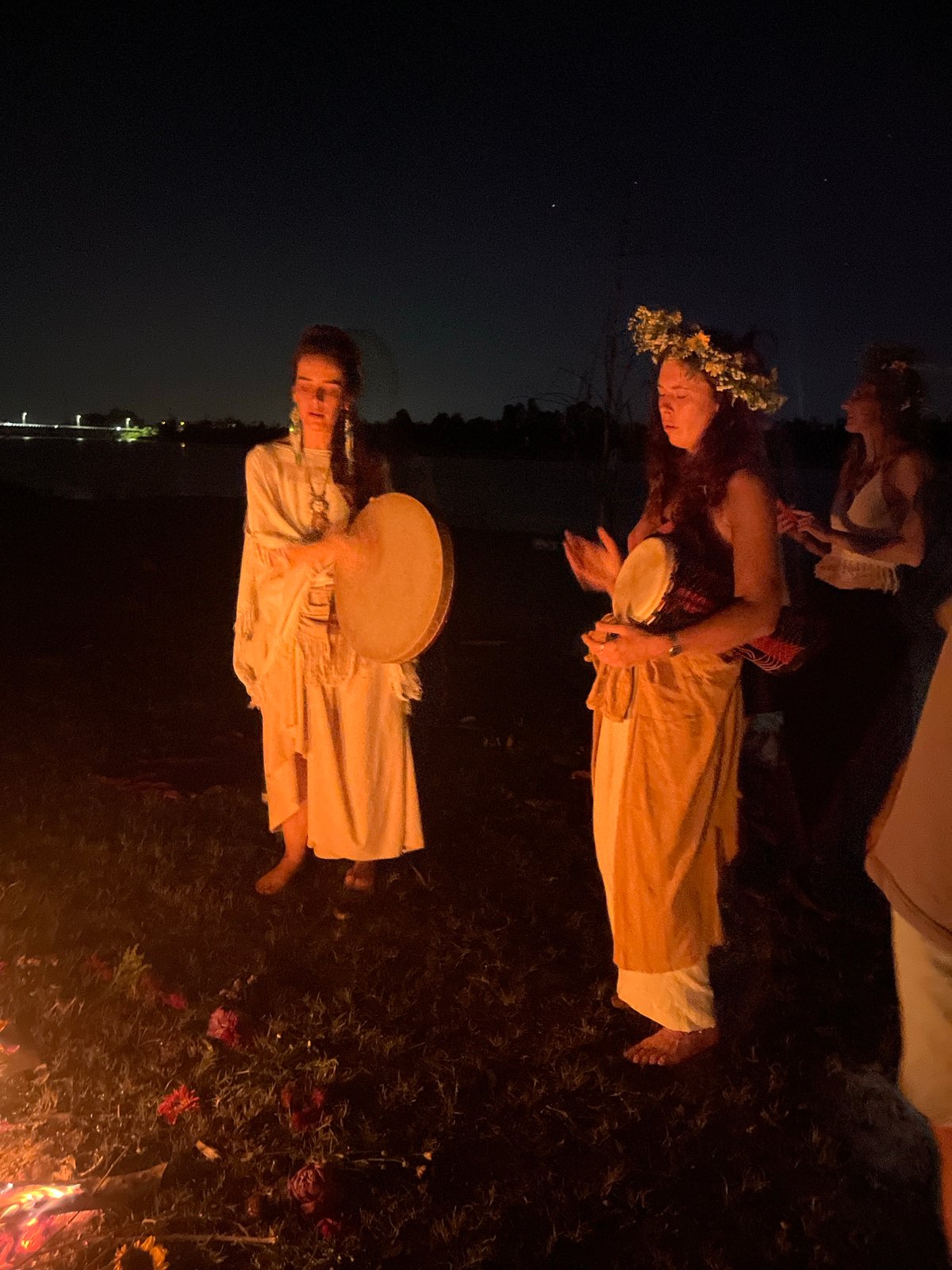 Nighttime ritual gathering with drums and bonfire in Hội An