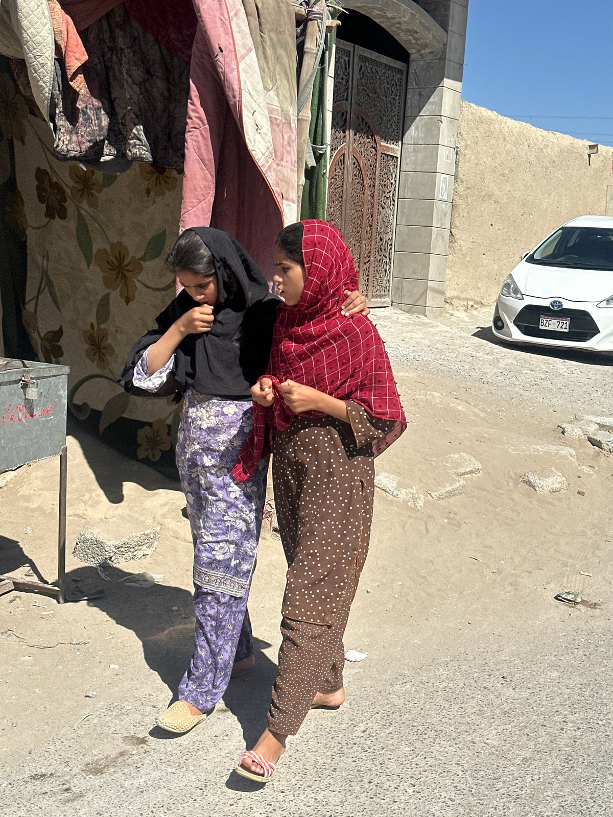 Two women walk together in Quetta semi-urban area