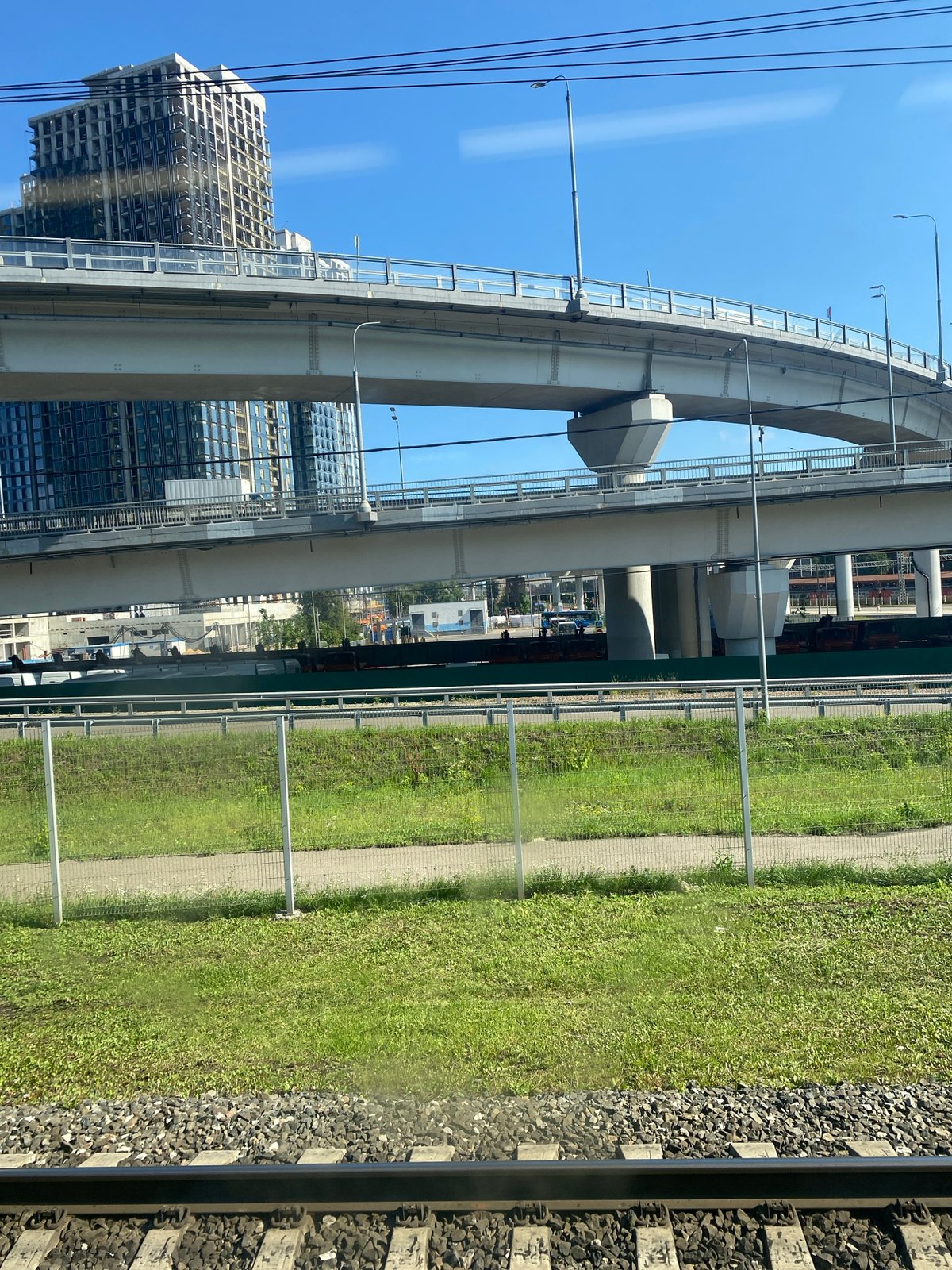 Train ride through a city of cranes, churches, and high-rises