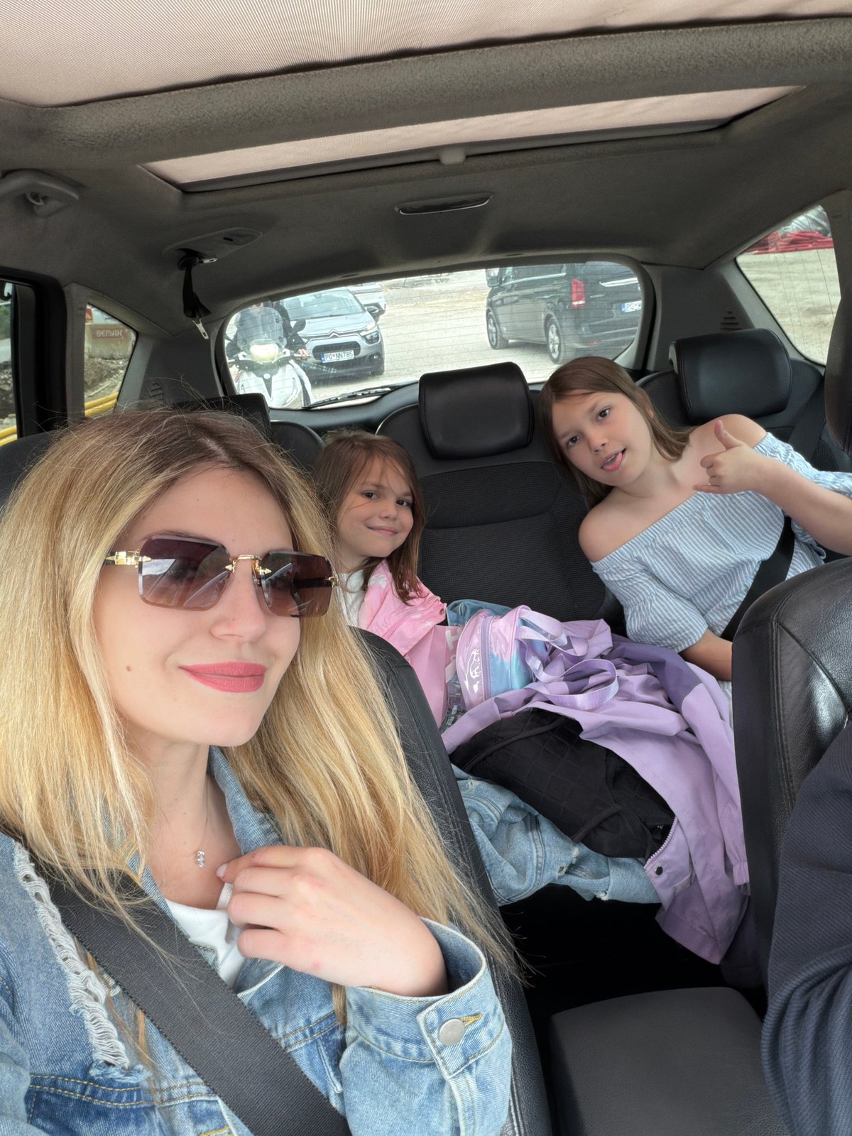 Woman and two girls travel by car in Montenegro