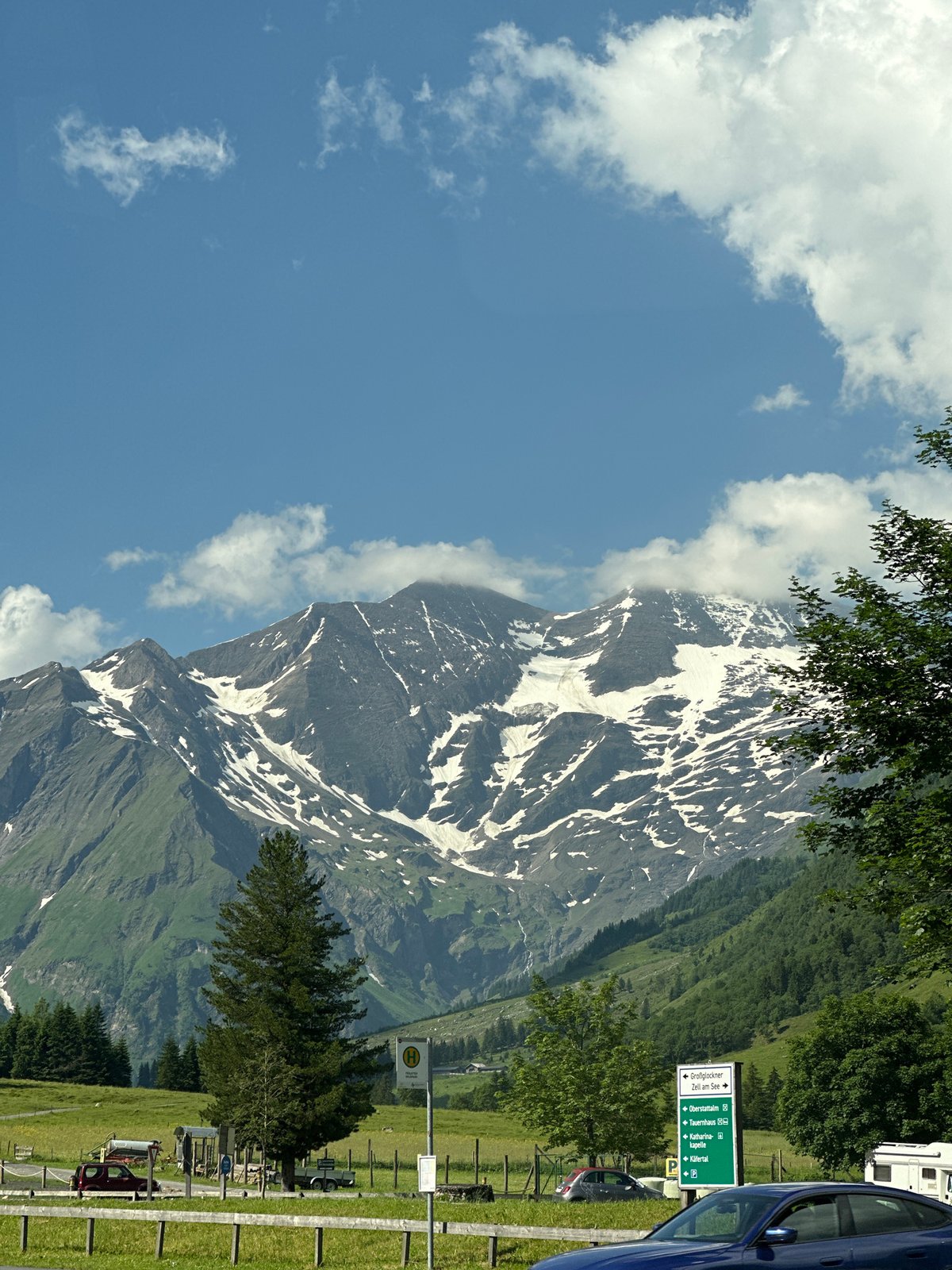 Sports cars cruise the Großglockner High Alpine Road on a clear morning