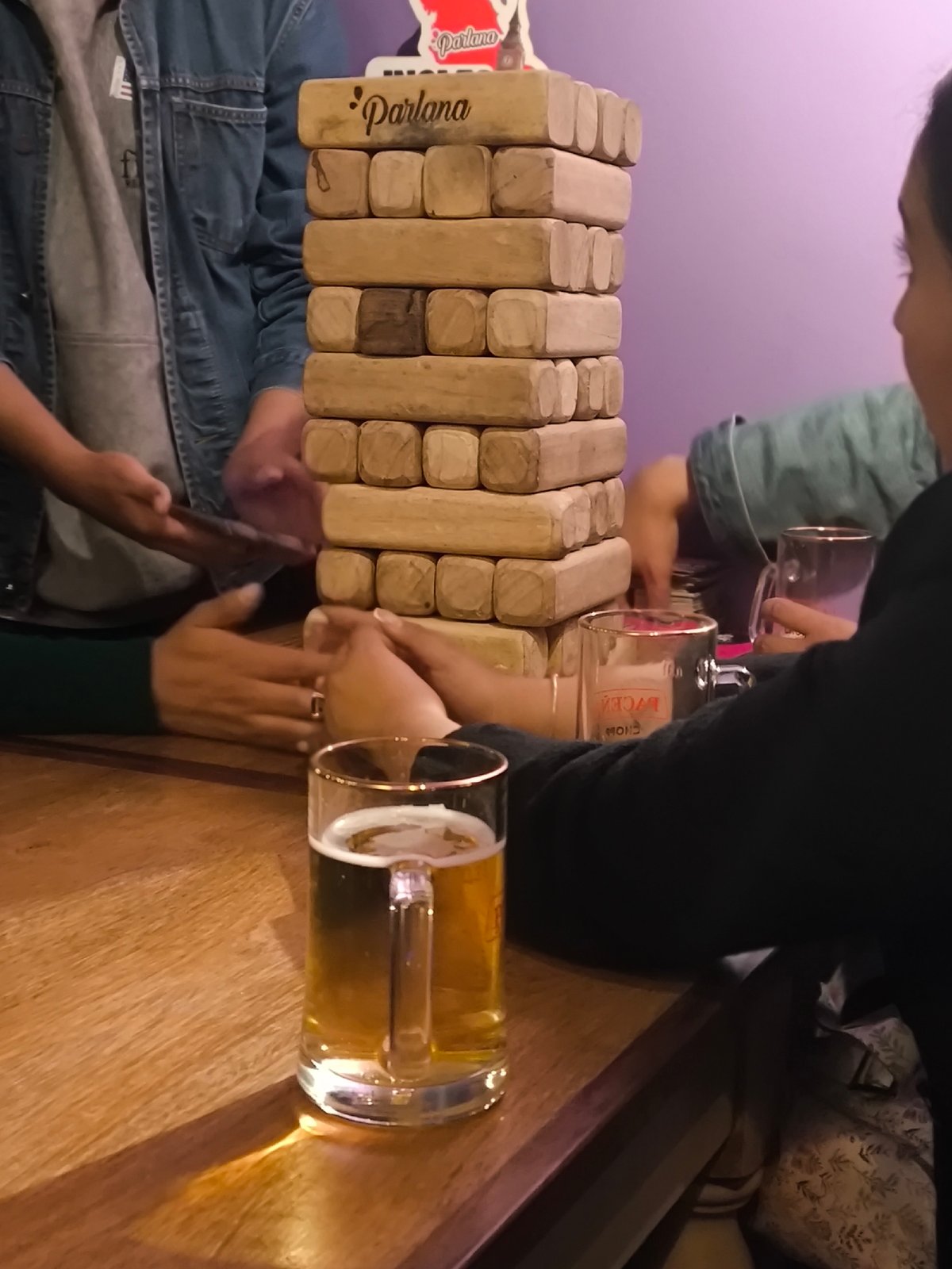 Late-night social gathering features Jenga, flags, beer in La Paz