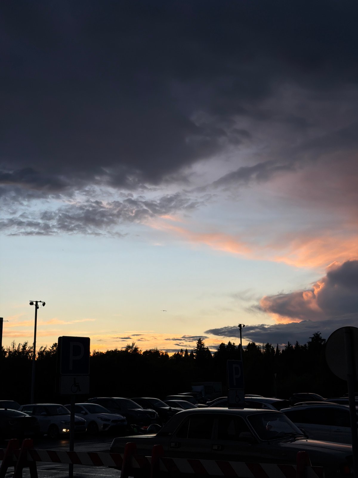 Evening scenes documented across Izhevsk parking areas, dramatic clouds