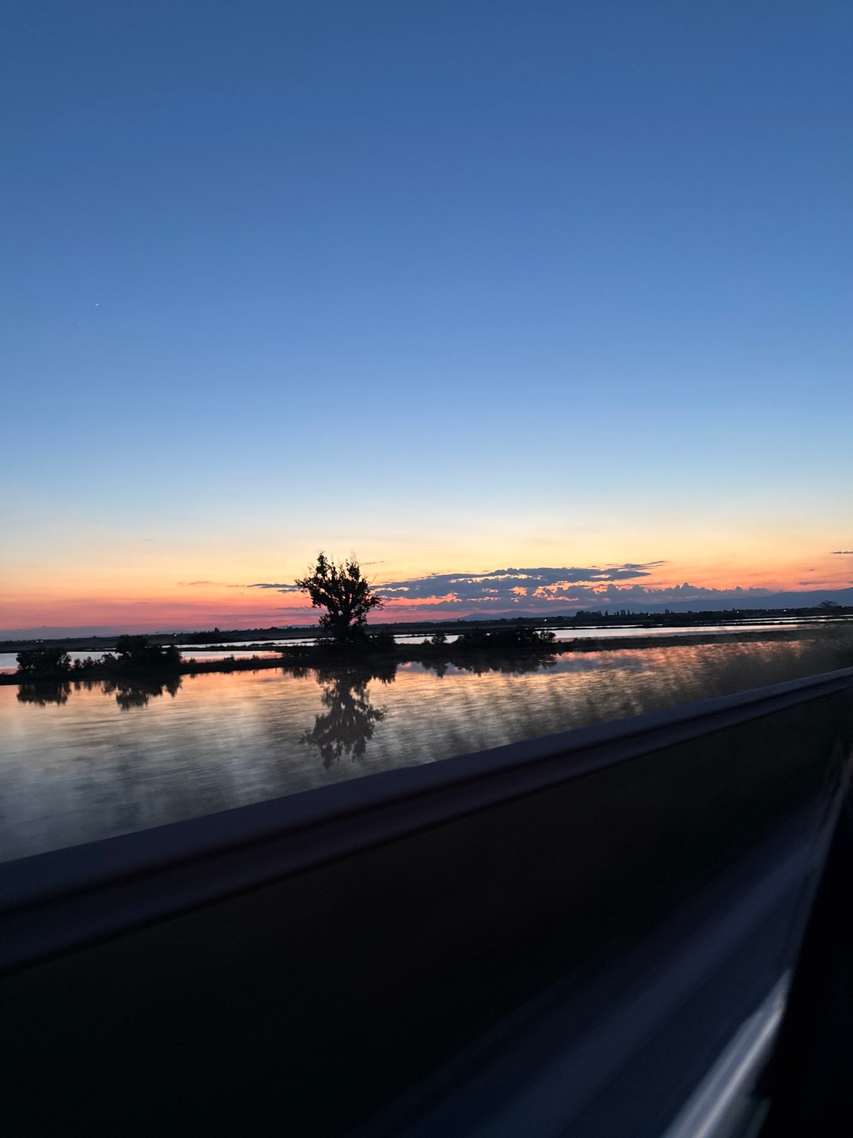 Driver Documents Sunset Journey Through Rural Landscape