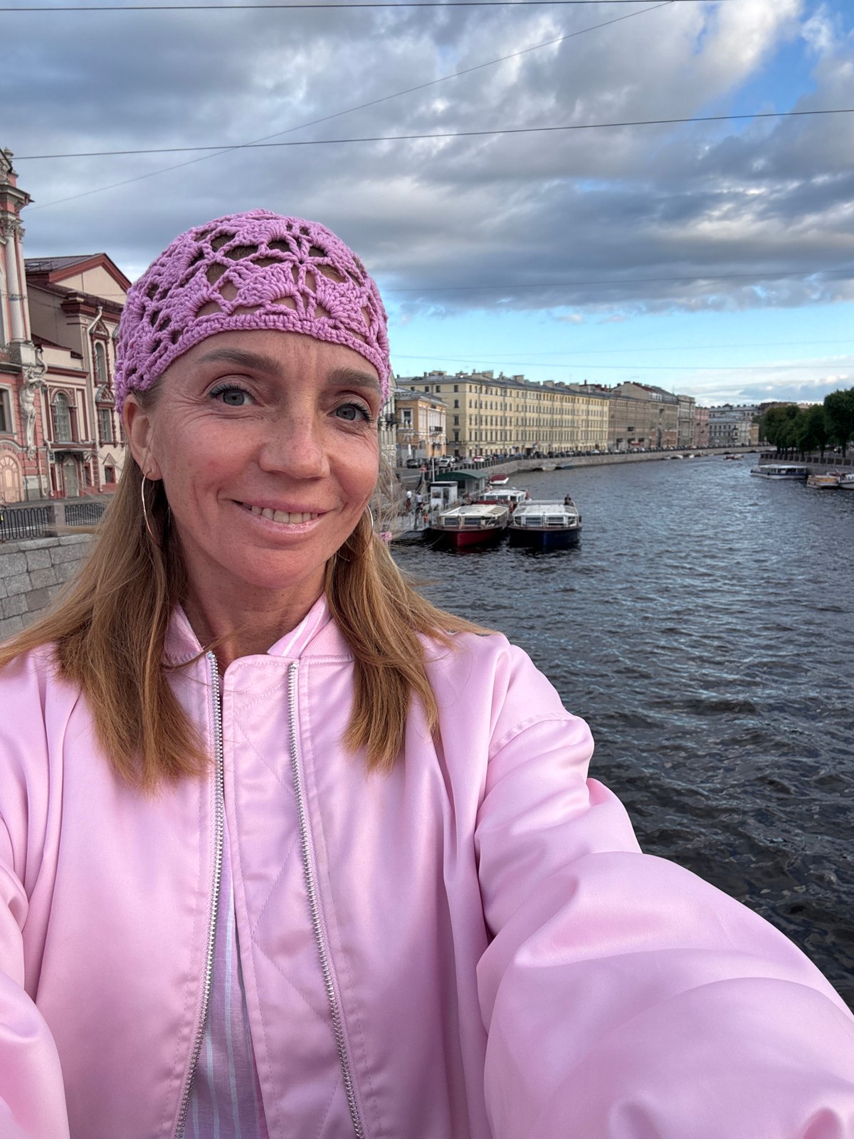 Tourist captures selfies during Saint Petersburg canal boat tour