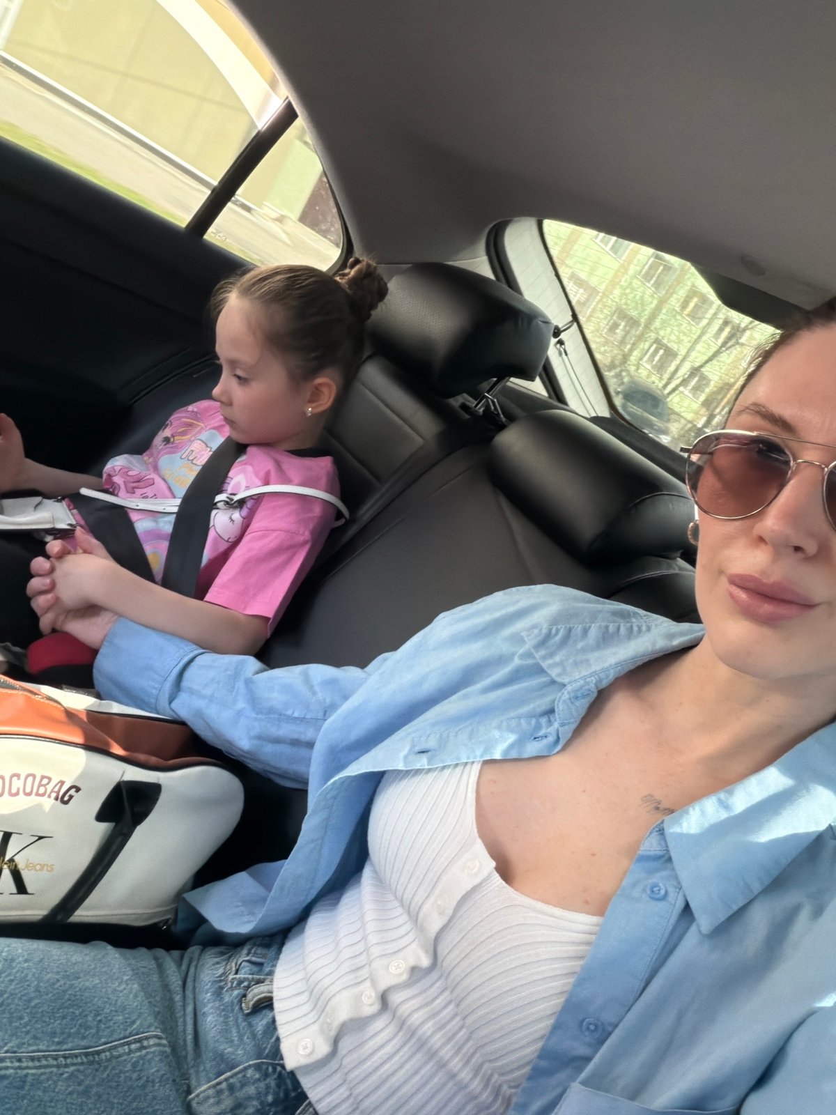 Woman takes car selfie with child in Perm, Russia