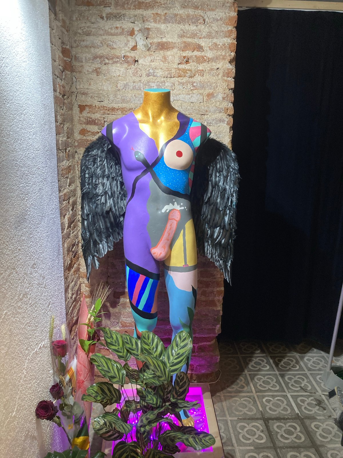 Artistic mannequin with abstract designs spotted in dimly lit area