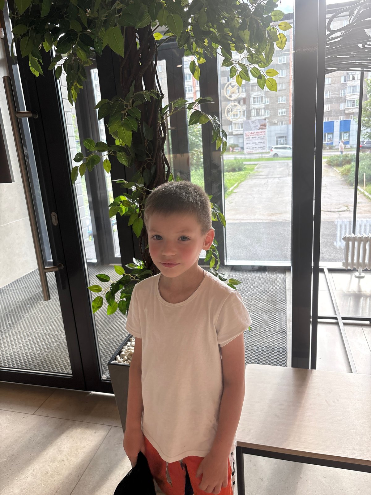 Boy in baseball cap observed across Izhevsk locations