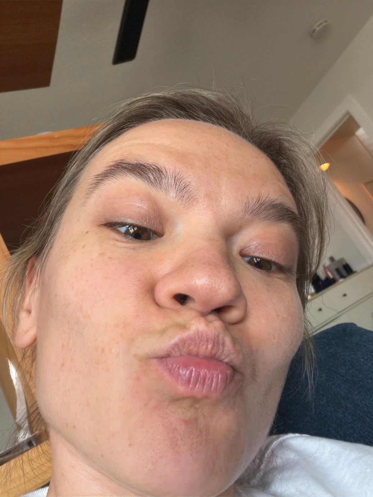 Person takes puckered-lip selfie indoors in Solana Beach