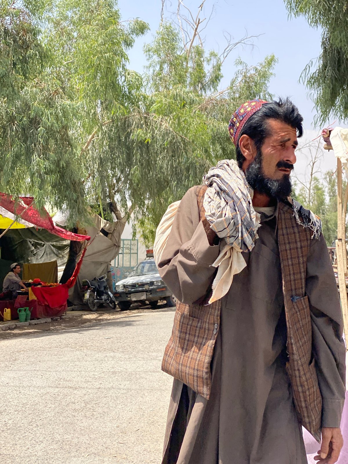 Street life in Kandahar: market stalls and a wheelbarrow