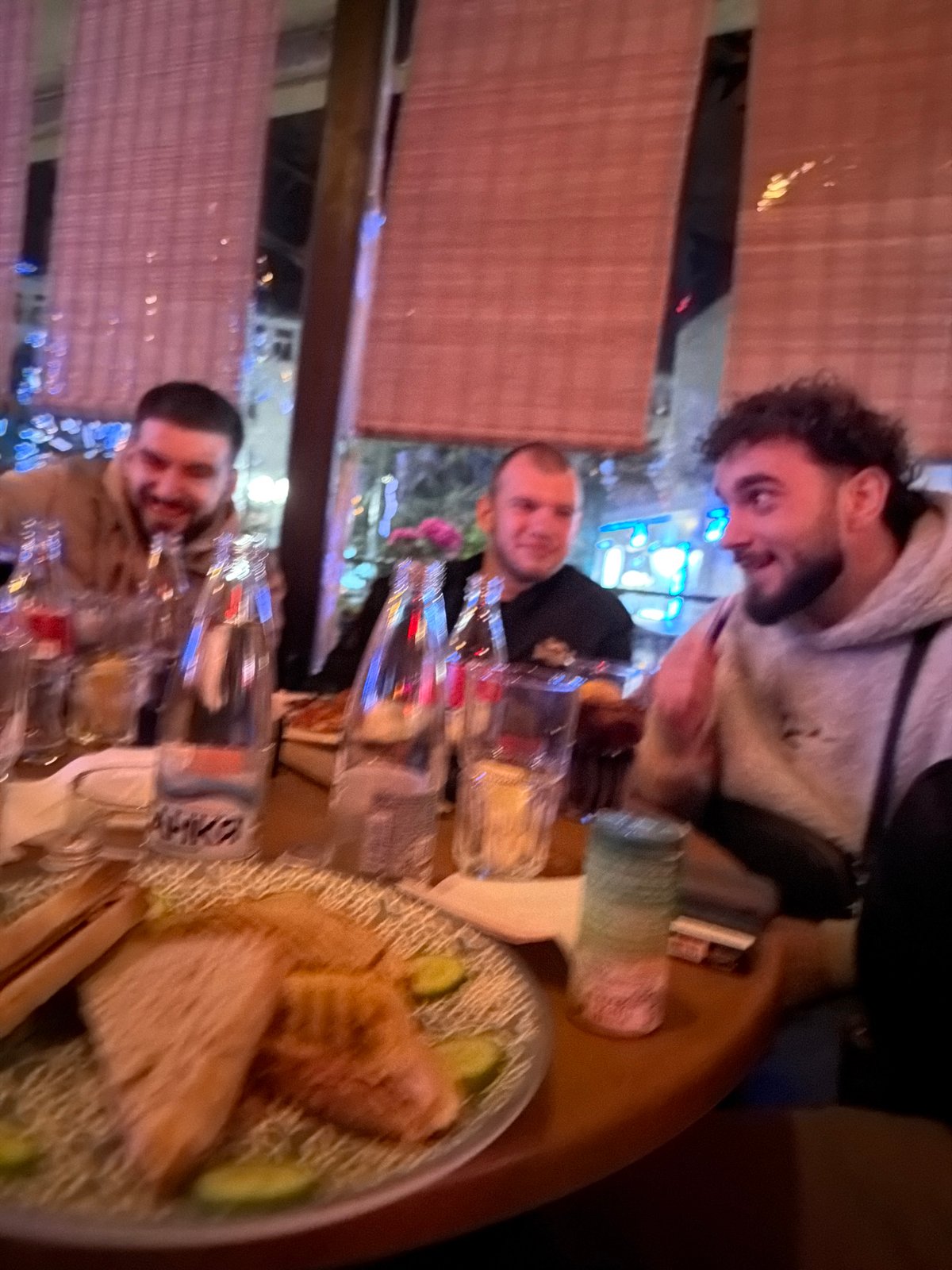 Three men dine together at restaurant in Chirpan